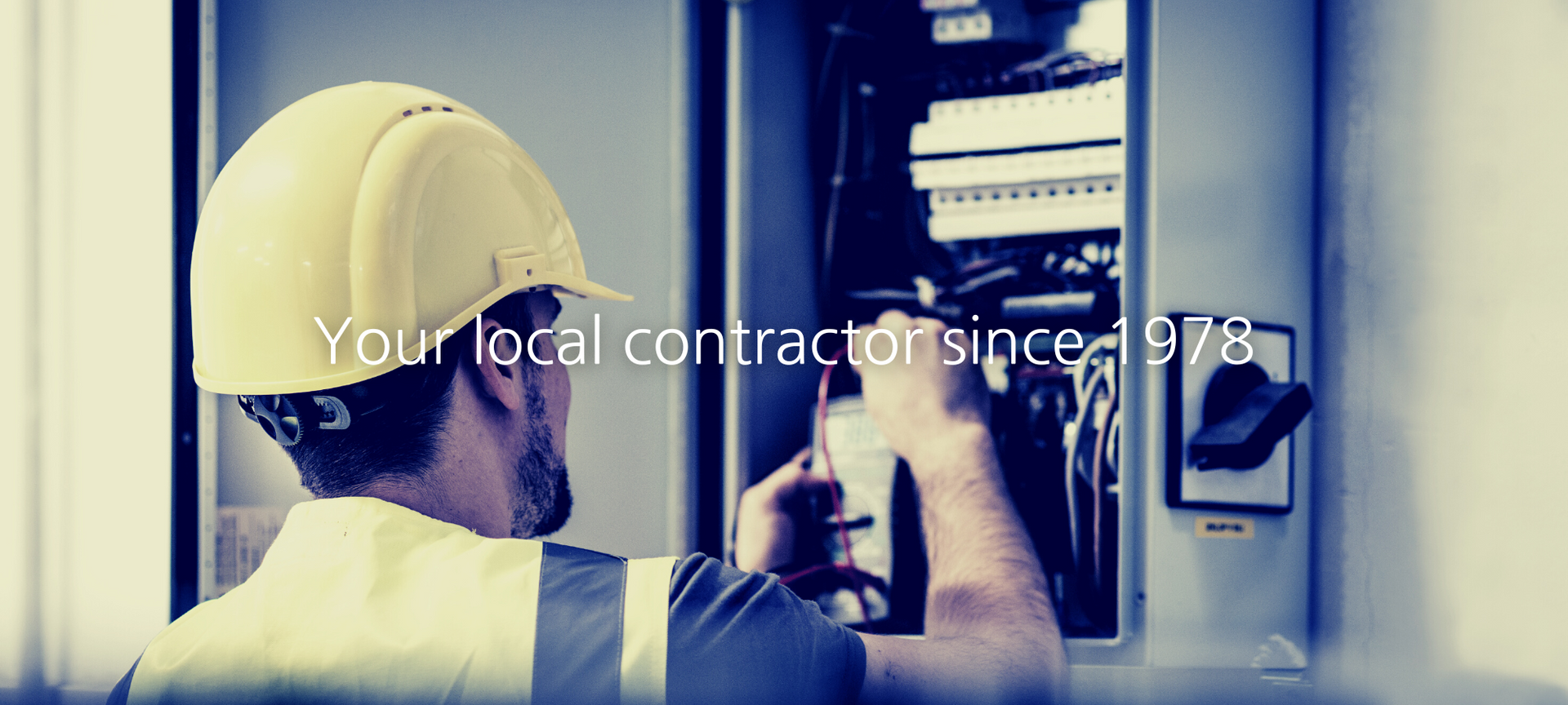 A contractor in a yellow hard hat and high-visibility vest services an electrical panel. Text reads: Your local contractor.