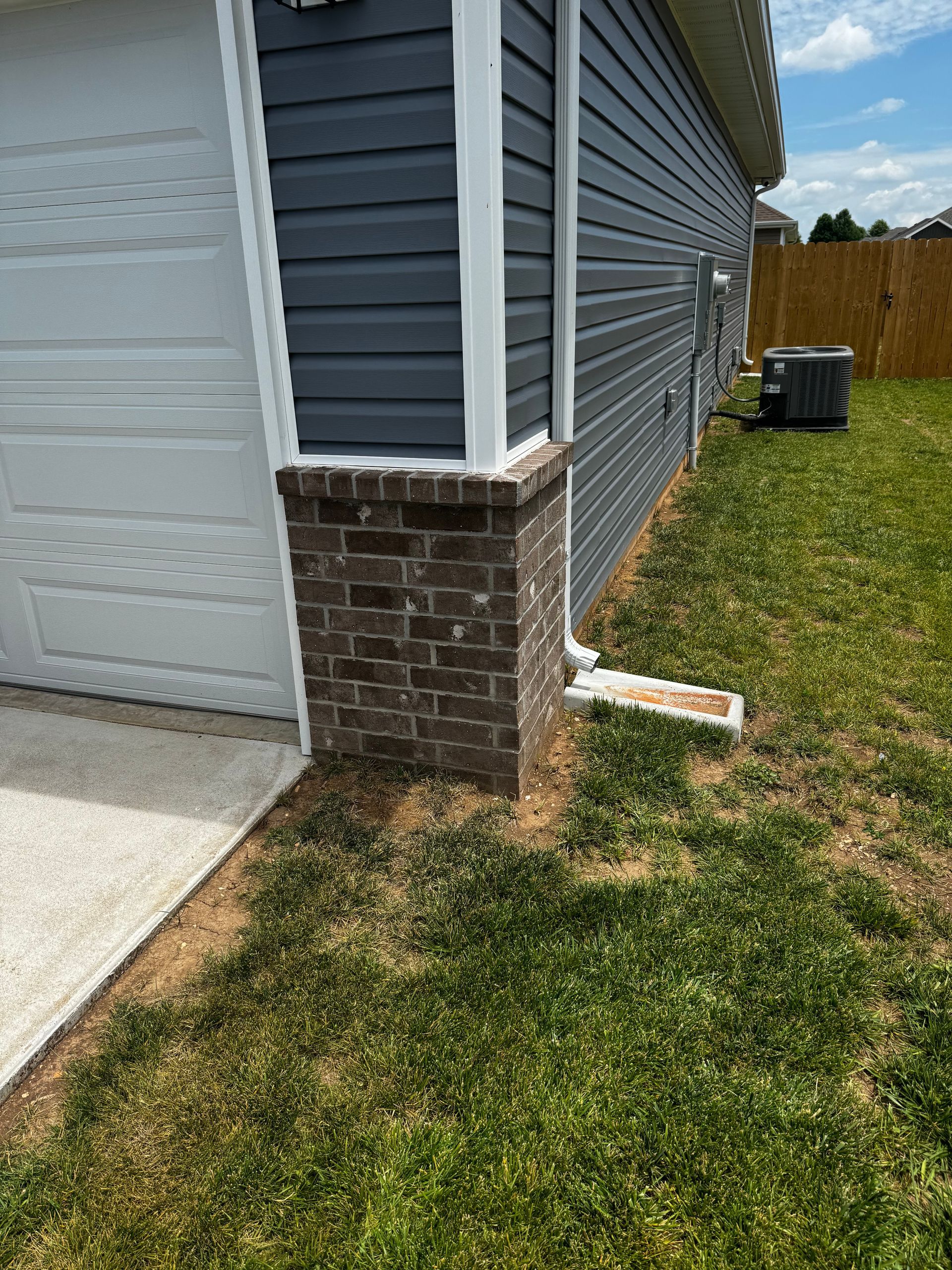 The side of a house with a white garage door