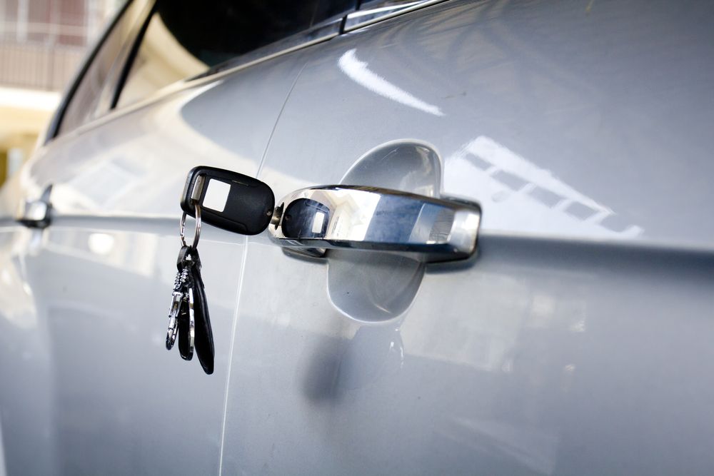 Spare Keys Hanging From the Door Handle of a Silver Car — North East Locksmiths in Wodonga, VIC