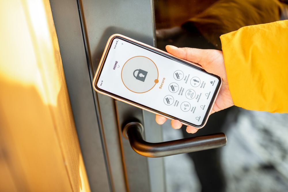 Person Unlocking a Door With a Smartphone, Interface Shows a Lock Icon — North East Locksmiths in Wodonga, VIC