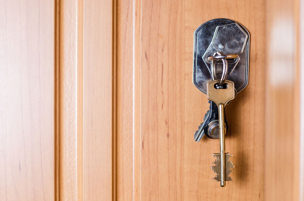 Old Keys Hanging in an Antique Door Lock on a Wooden Door — North East Locksmiths in Wodonga, VIC