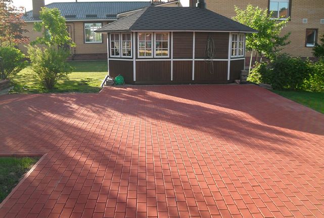 Red shingle roof in a residential backyard with a small gazebo and surrounding trees.