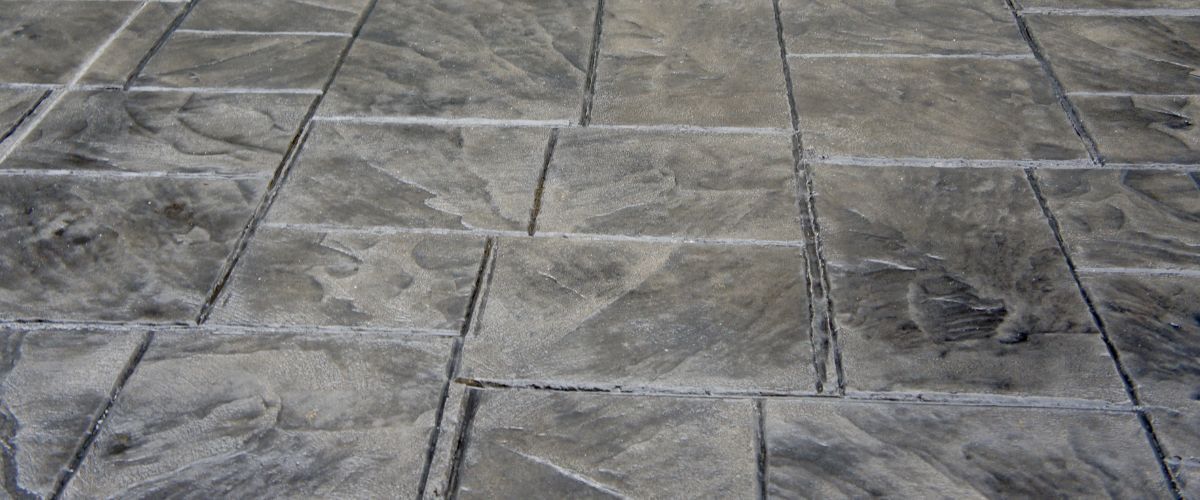 Gray stone pavement with rectangular slabs and visible seams