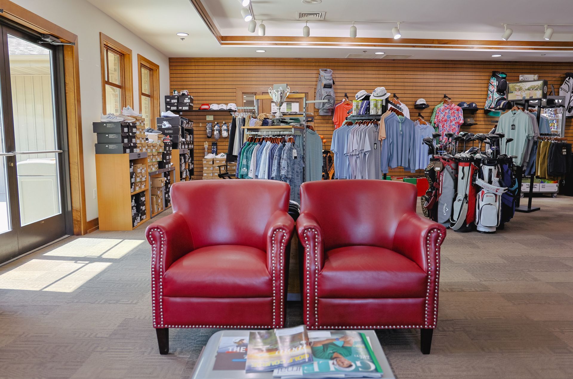 Two red leather chairs are sitting next to each other in a store.
