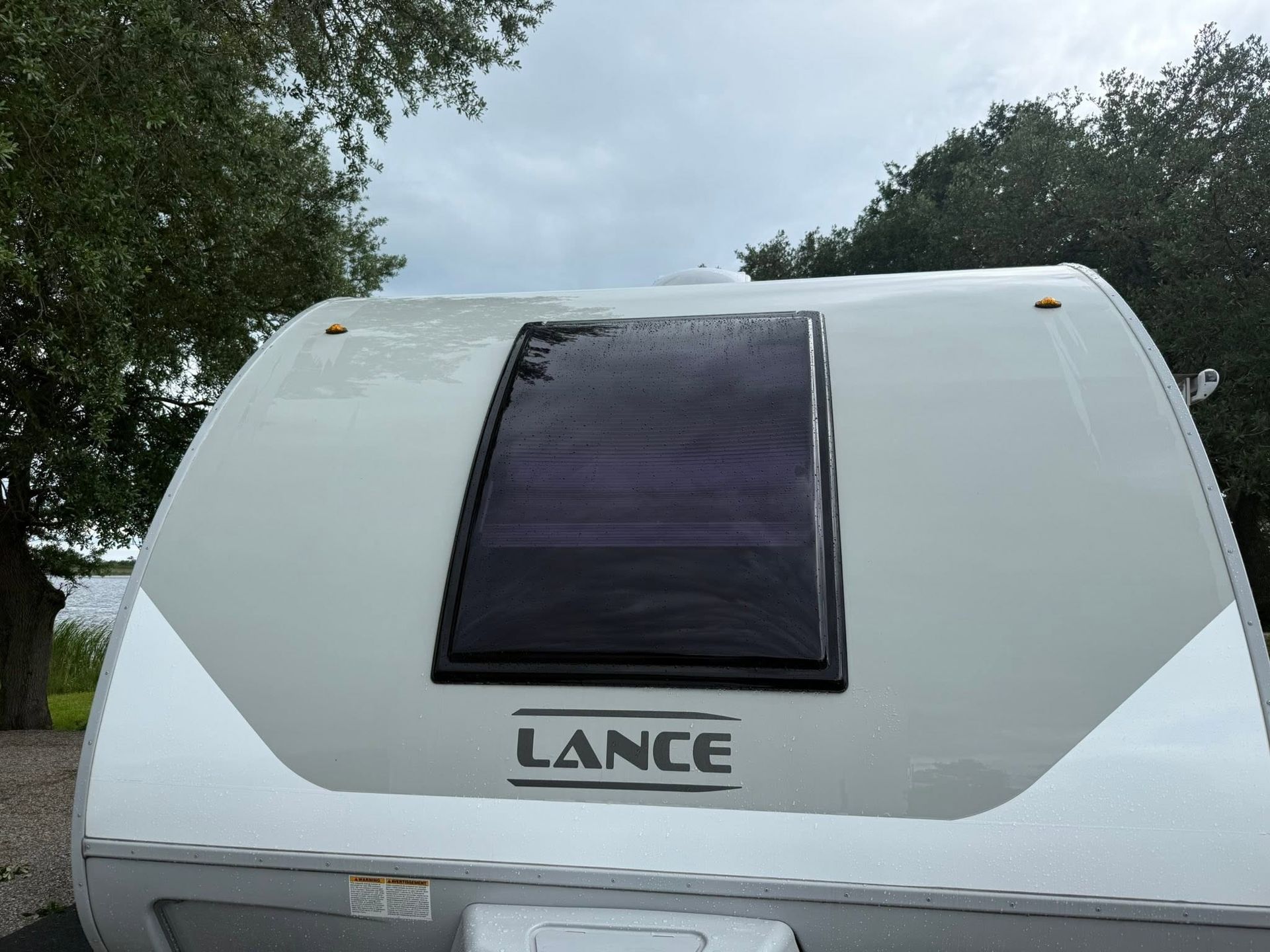 Man wiping the windshield inside a wooden RV with a cloth