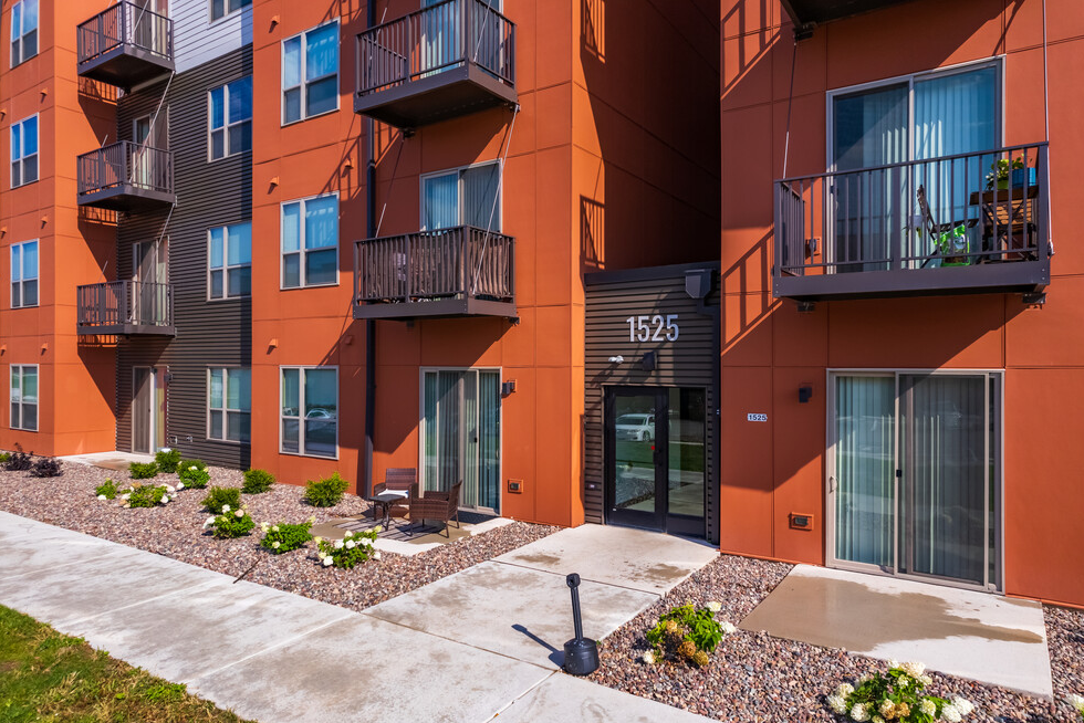 A large apartment building with a lot of windows and balconies.