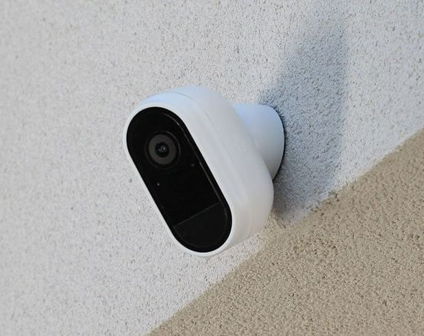 A White Security Camera Is Mounted To A White Wall — Dateline Computers Authorised Jaycar Reseller In Cannonvale, QLD