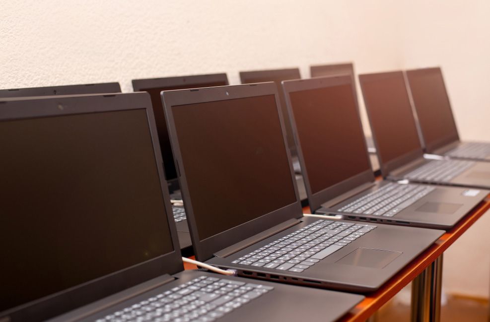 A Row Of Laptops Sitting On Top Of A Wooden Table — Dateline Computers Authorised Jaycar Reseller In Cannonvale, QLD