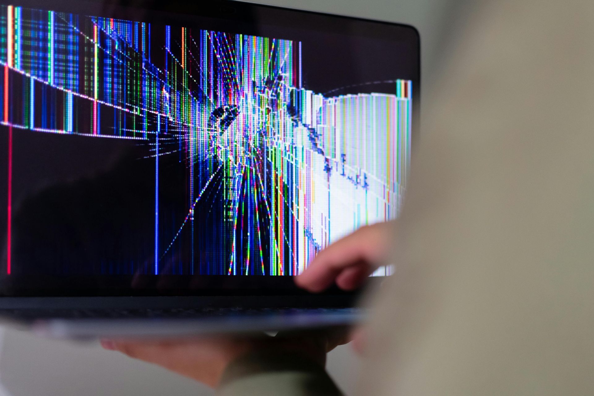 A Person Is Holding A Laptop With A Broken Screen — Dateline Computers Authorised Jaycar Reseller In Cannonvale, QLD