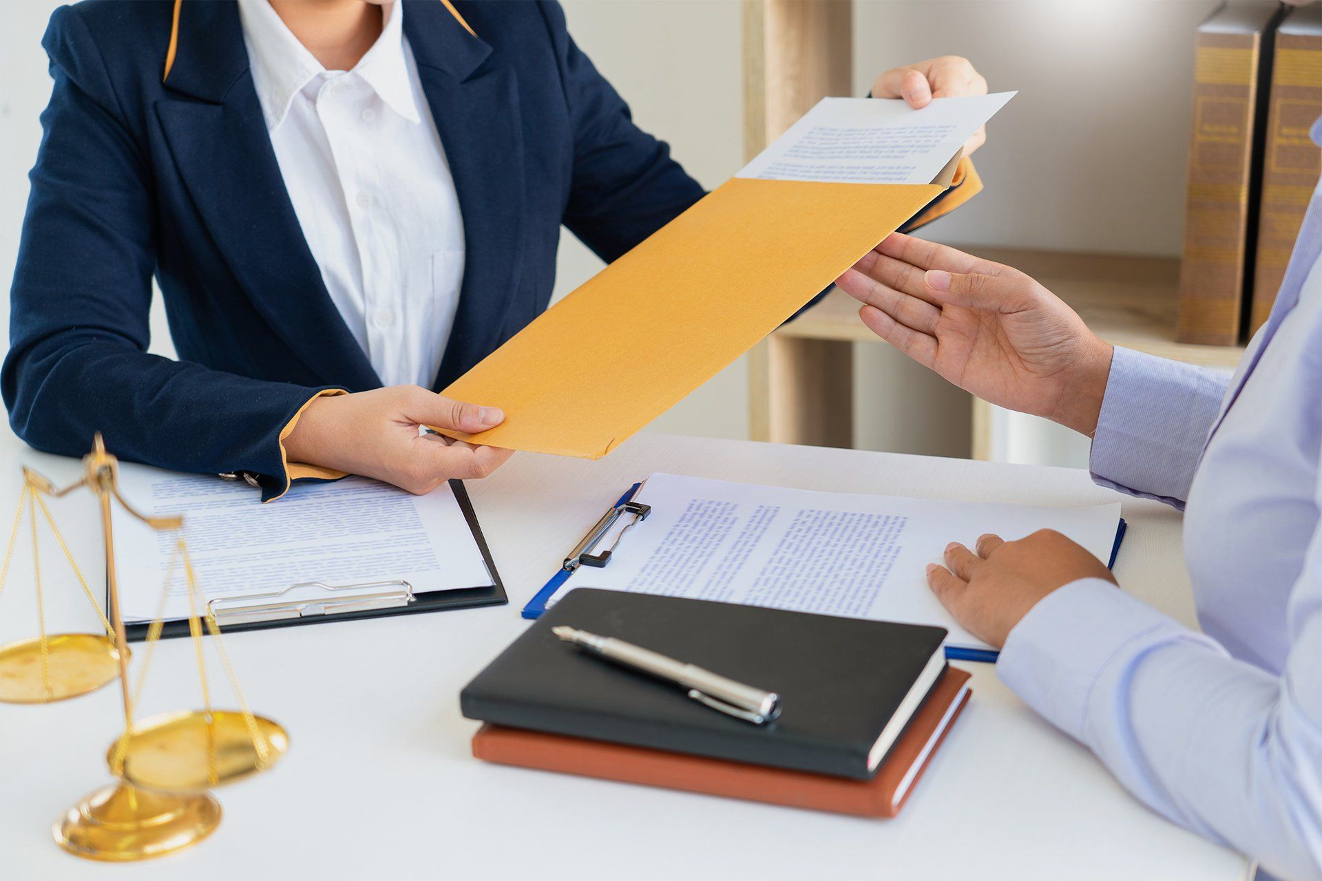 Client Handing Out Documents to His Attorney