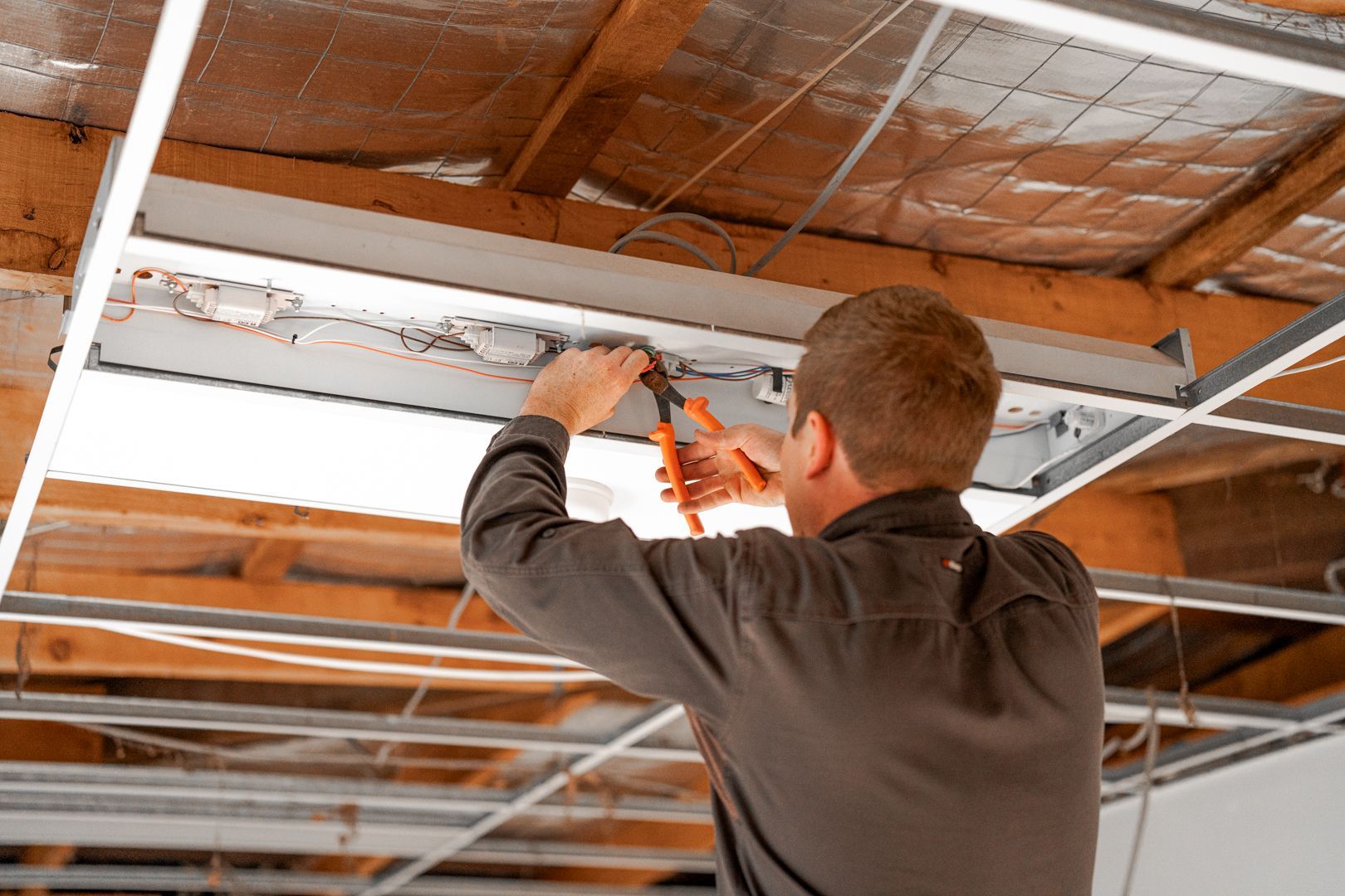 Integrated Services team member nstalling electrical 