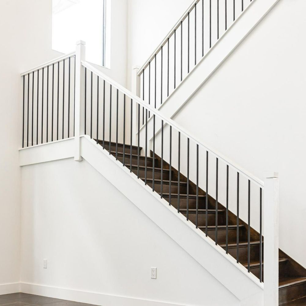An empty room with stairs leading up to the second floor