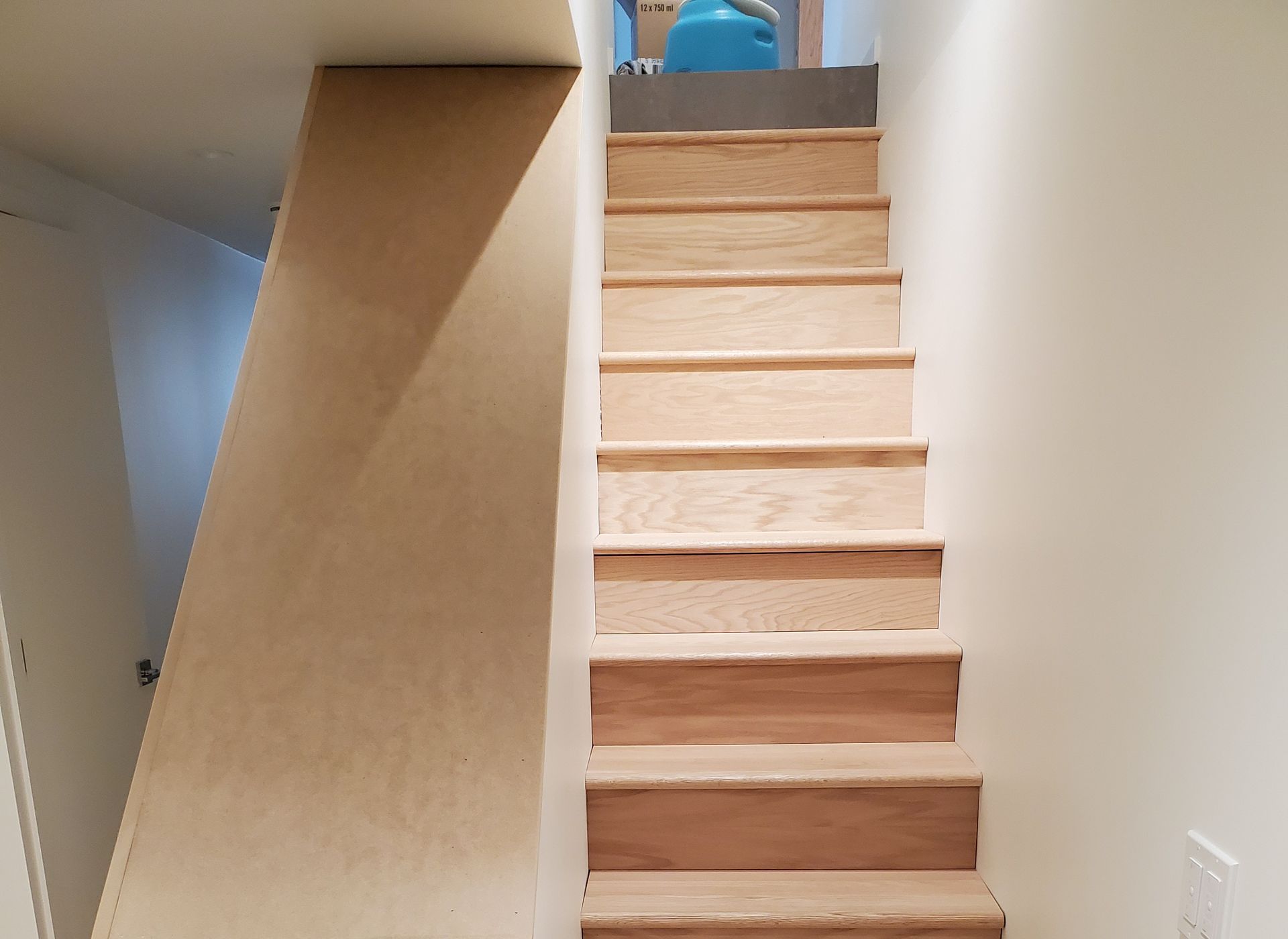 A wooden staircase leading up to the second floor of a house