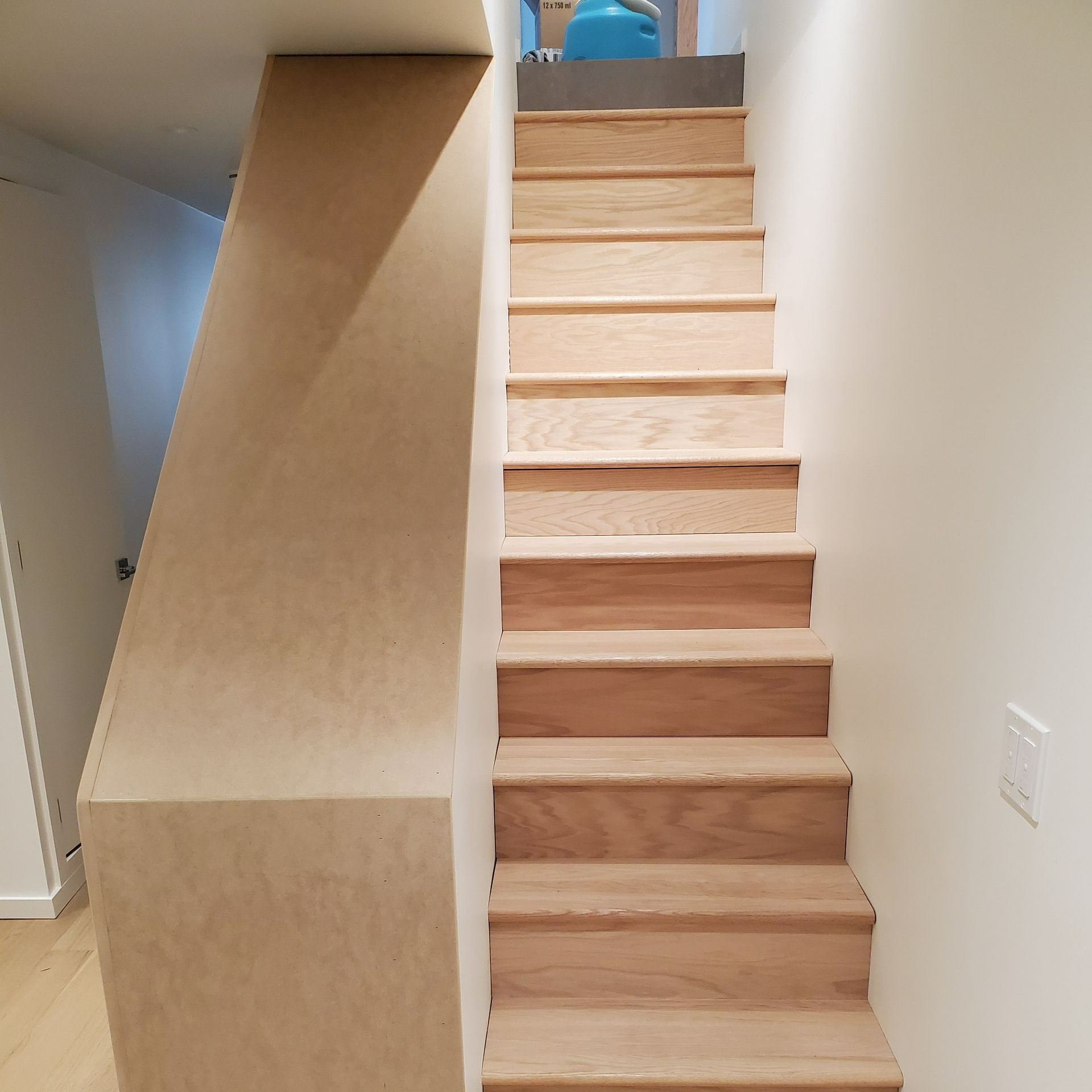 A wooden staircase leading up to the second floor of a house