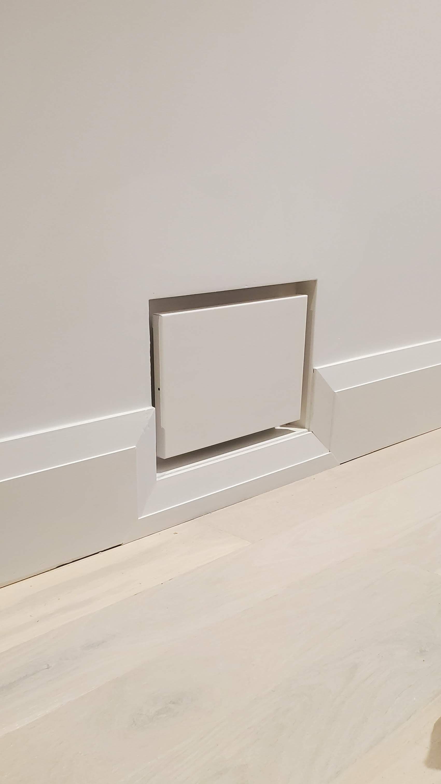 There is a hole in the wall that looks like a door.