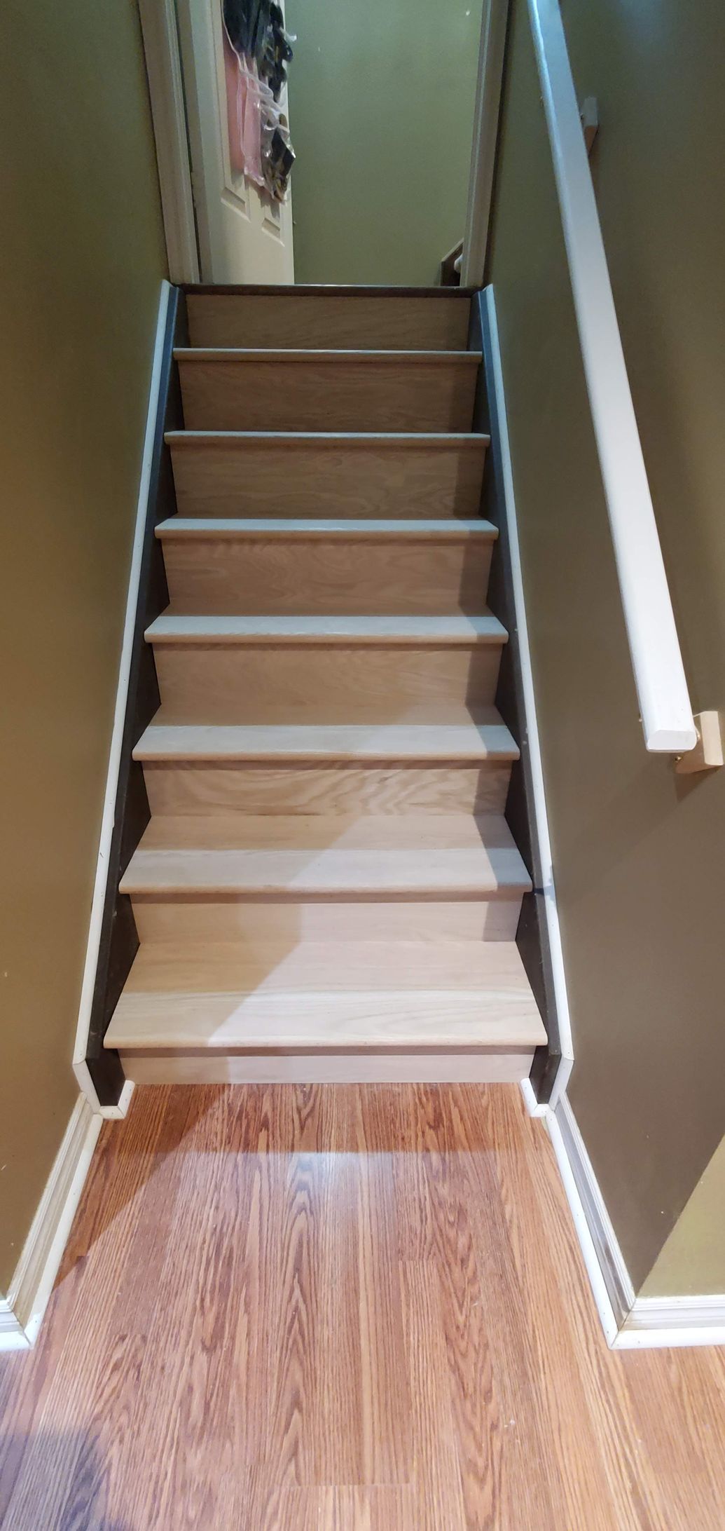 A set of stairs leading up to the second floor of a house.