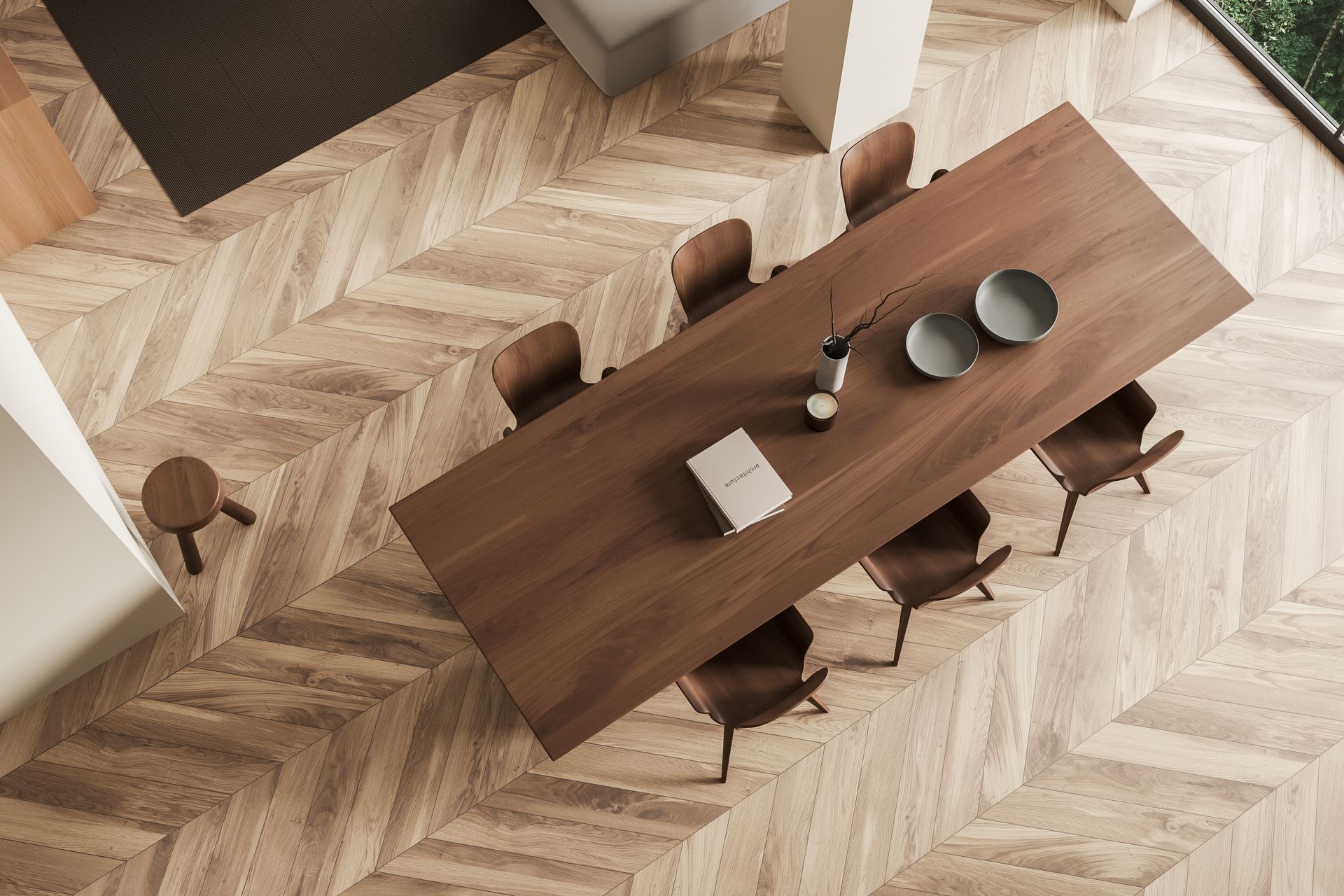 Top-down view of a wooden dining table with chairs, dishes, and decor on a chevron-patterned floor