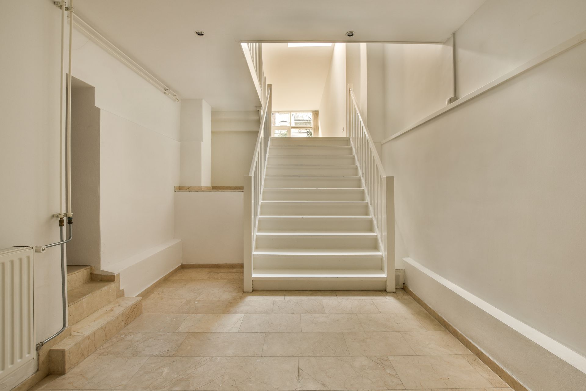 A basement with stairs leading up to the upper floor