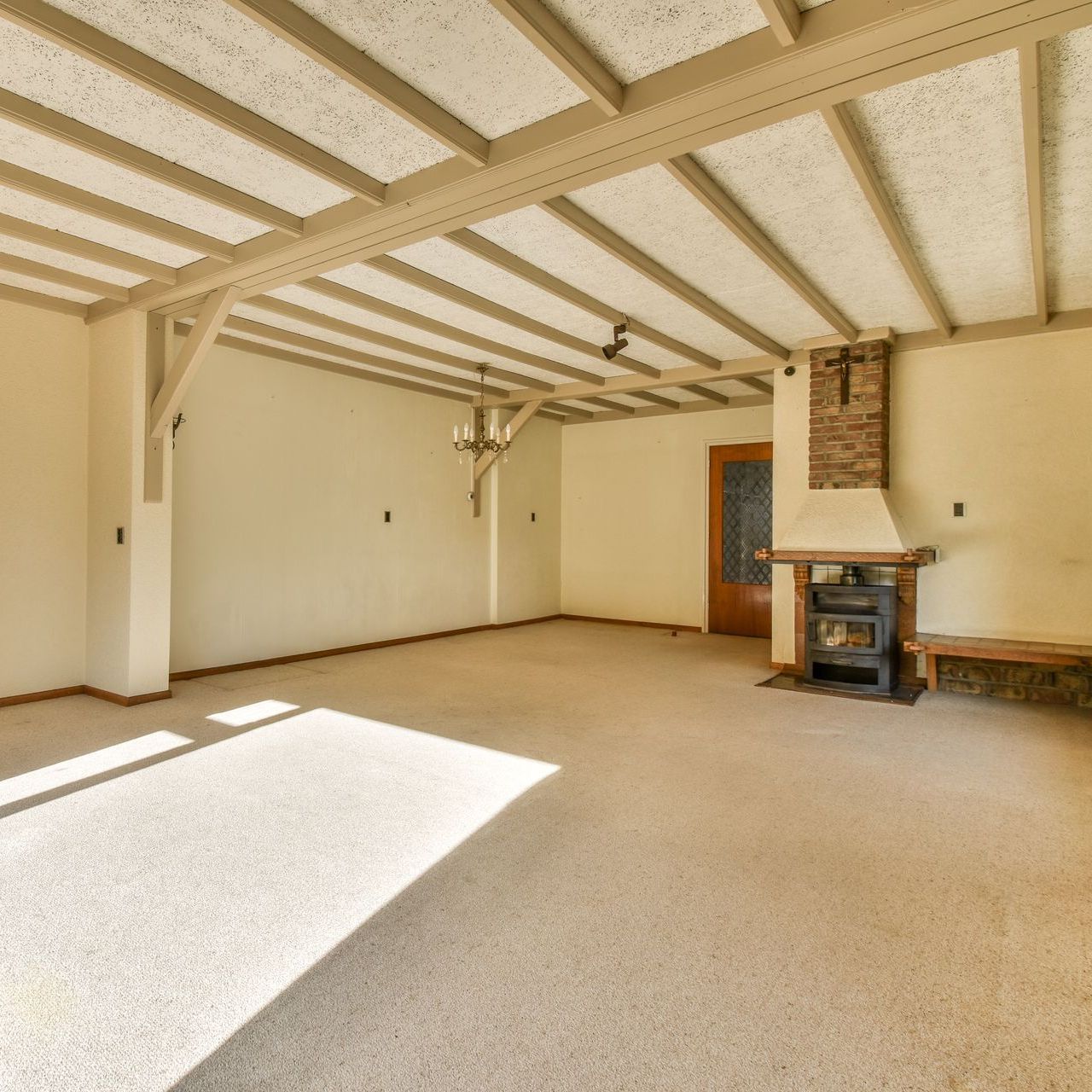 An empty basement with a fireplace in the middle