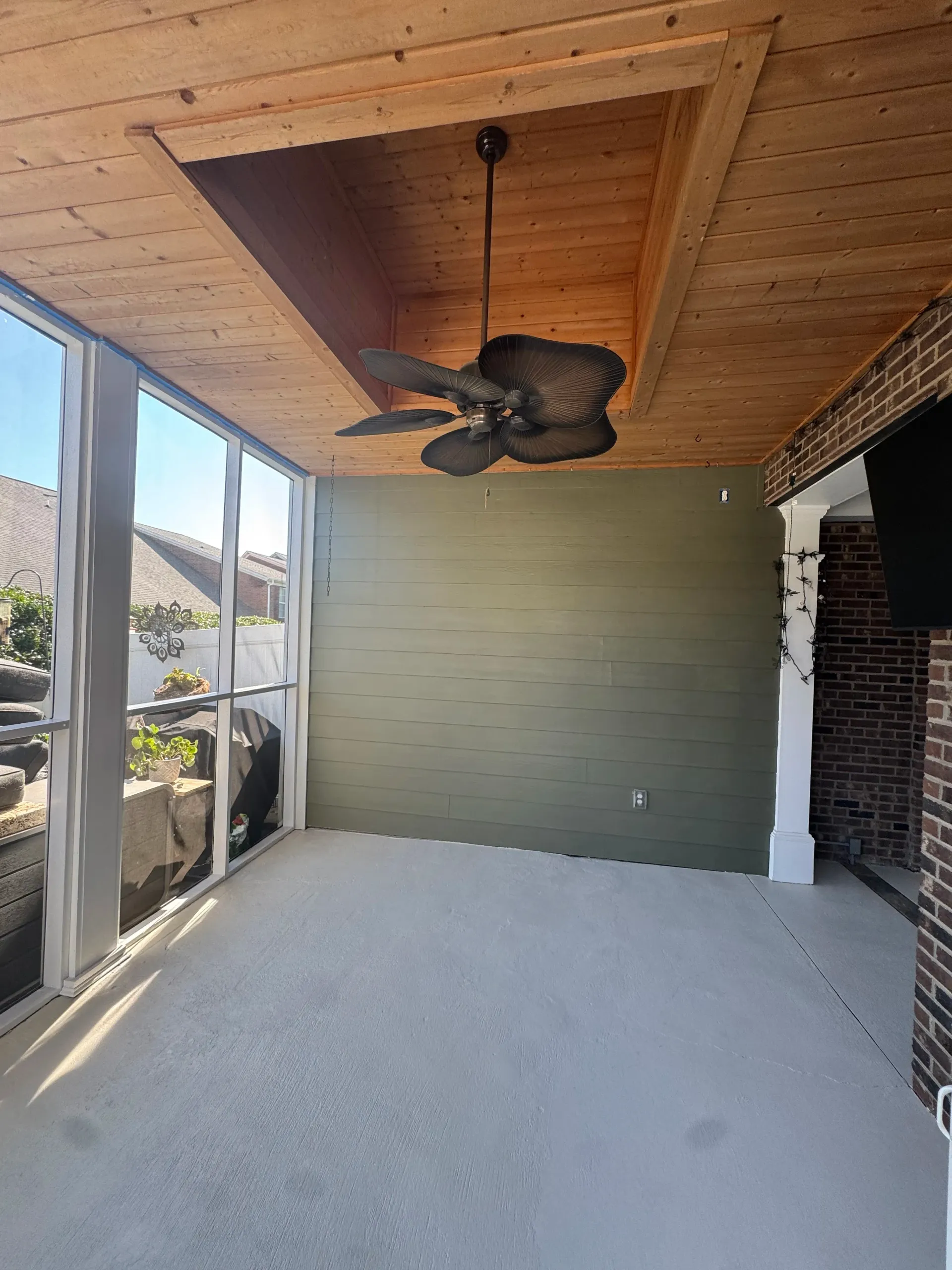 painted accent wall and epoxy floor coating on a covered porch in Simpsonville SC by True North Hand