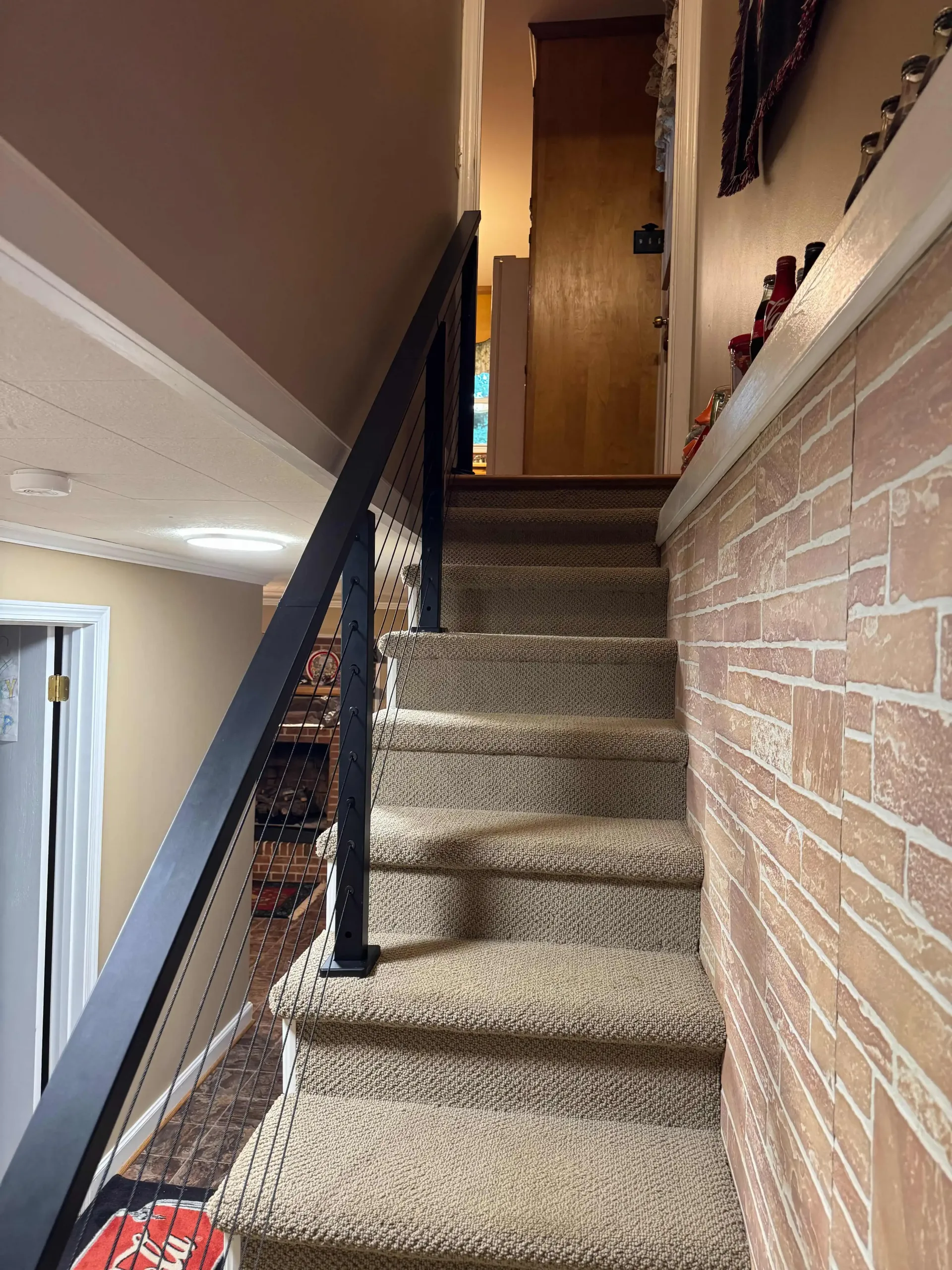 black cable handrail installed on an interior staircase in a Greer, SC home by True North Handyman