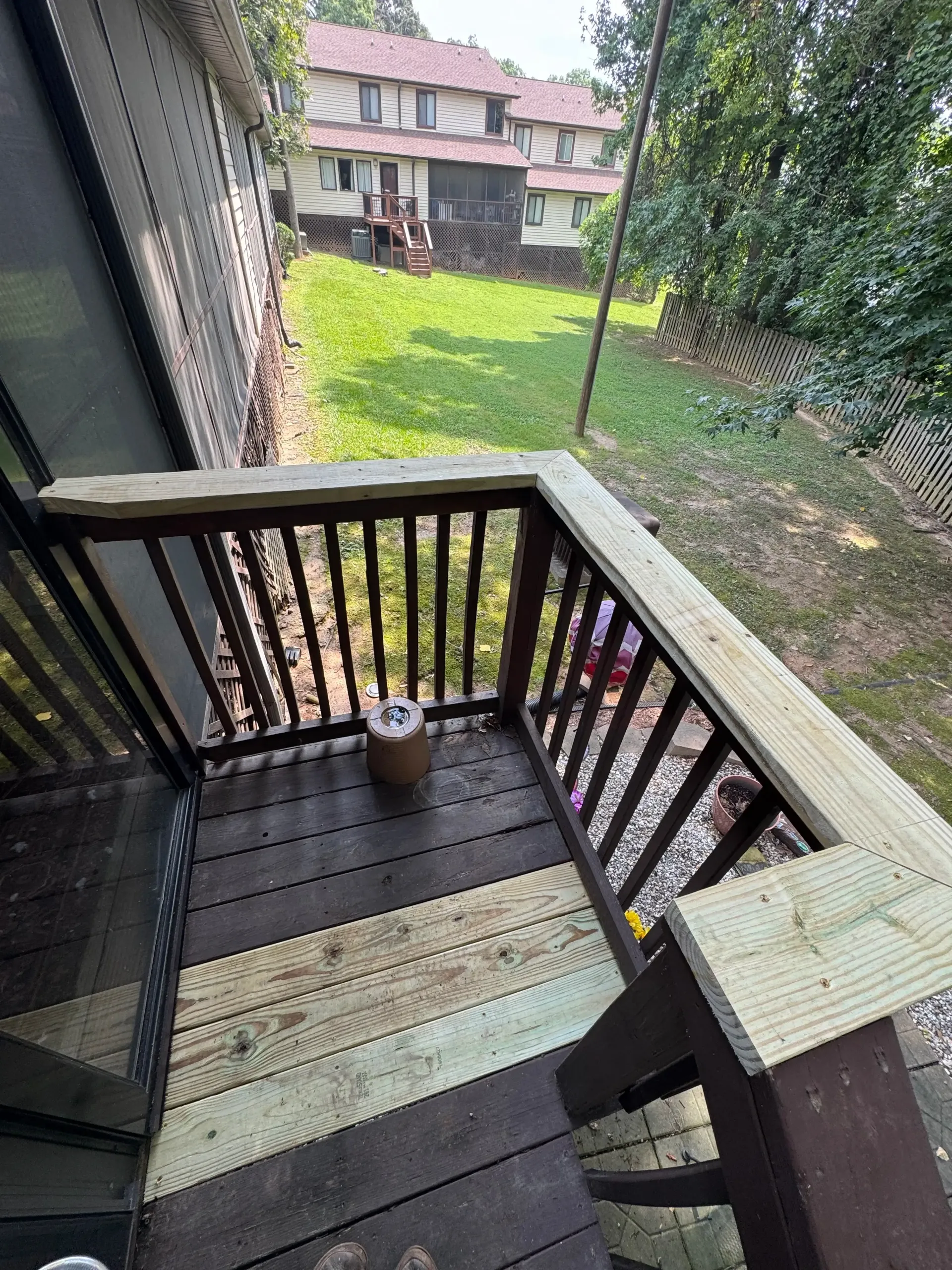 repaired deck handrail with new pressure-treated lumber on an elevated deck in Greenville SC by True