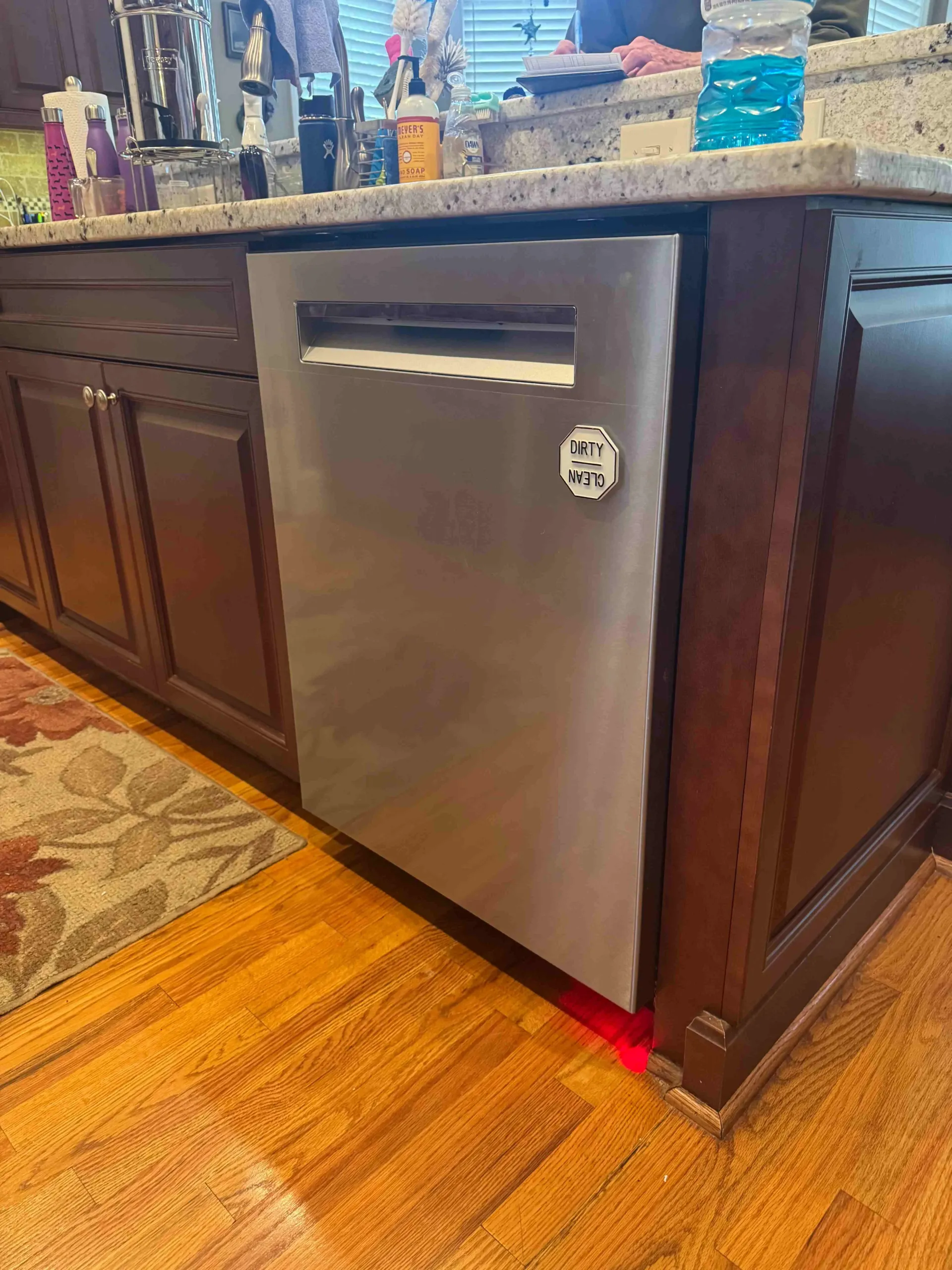 stainless steel dishwasher installed under a granite countertop in a Greenville SC kitchen island