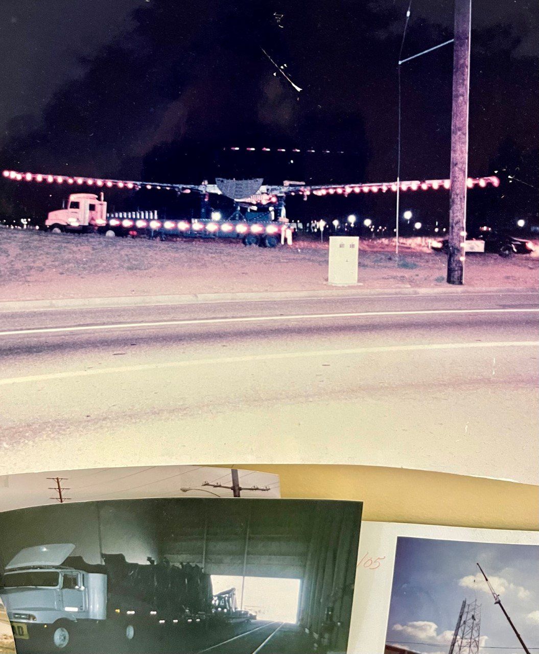 Night photo: semi-trucks, overhead lights strung across road. Below: additional photo of a truck.