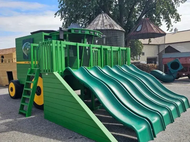 Wooden combine harvester playground built by Amish craftsmen in Lancaster County featuring six exciting slides.
