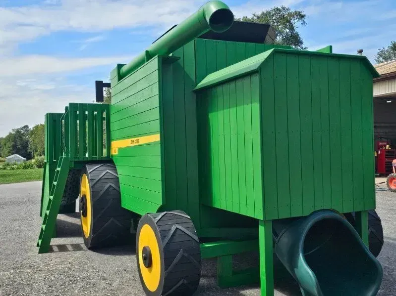 One-of-a-kind combine harvester playground with multiple slides, handcrafted for families, churches, and communities.