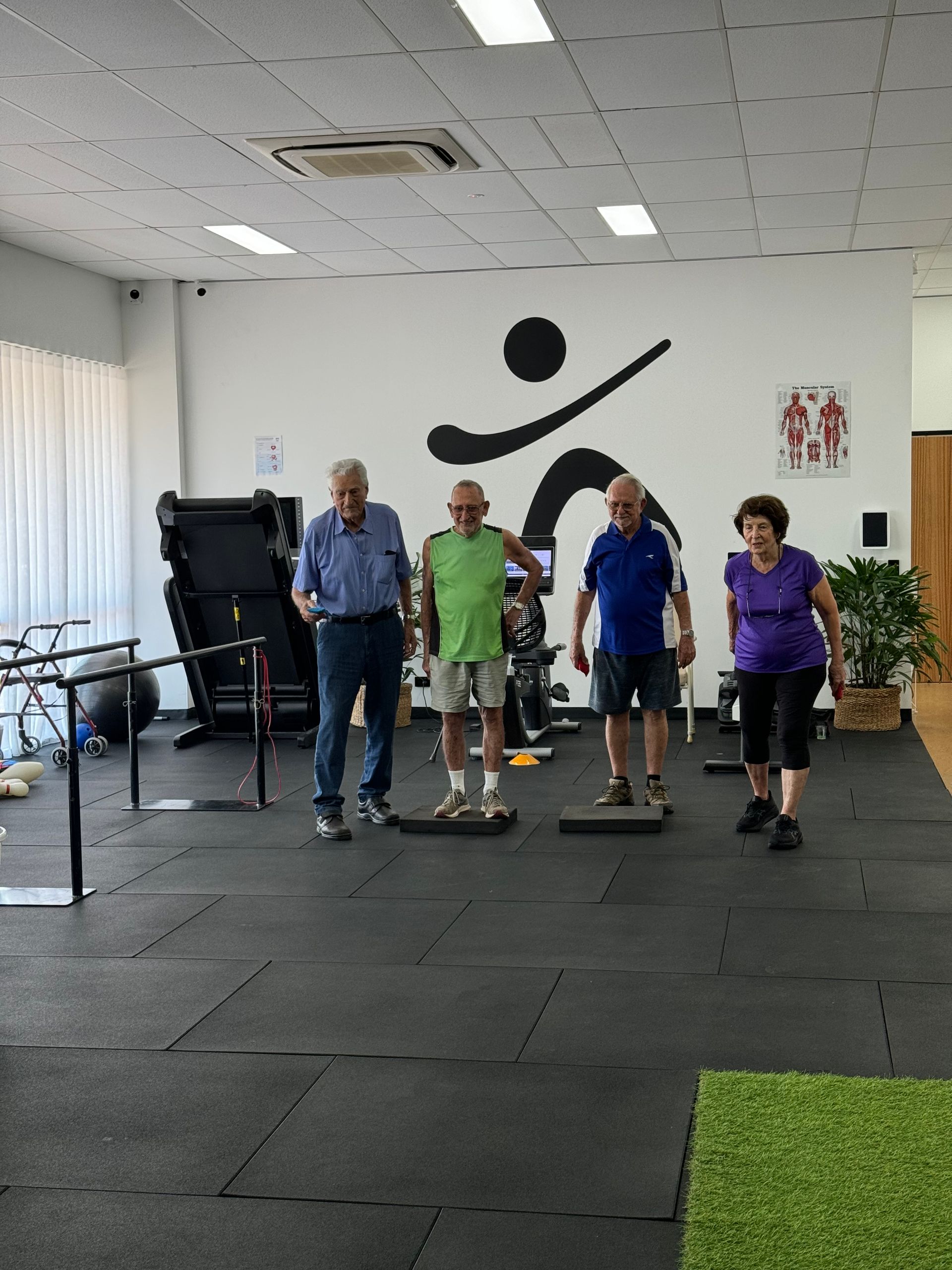 Four Adults Exercise on Balance Pads in a Brightly Lit Fitness Studio — Inner Balance Health in Coconut Grove, NT