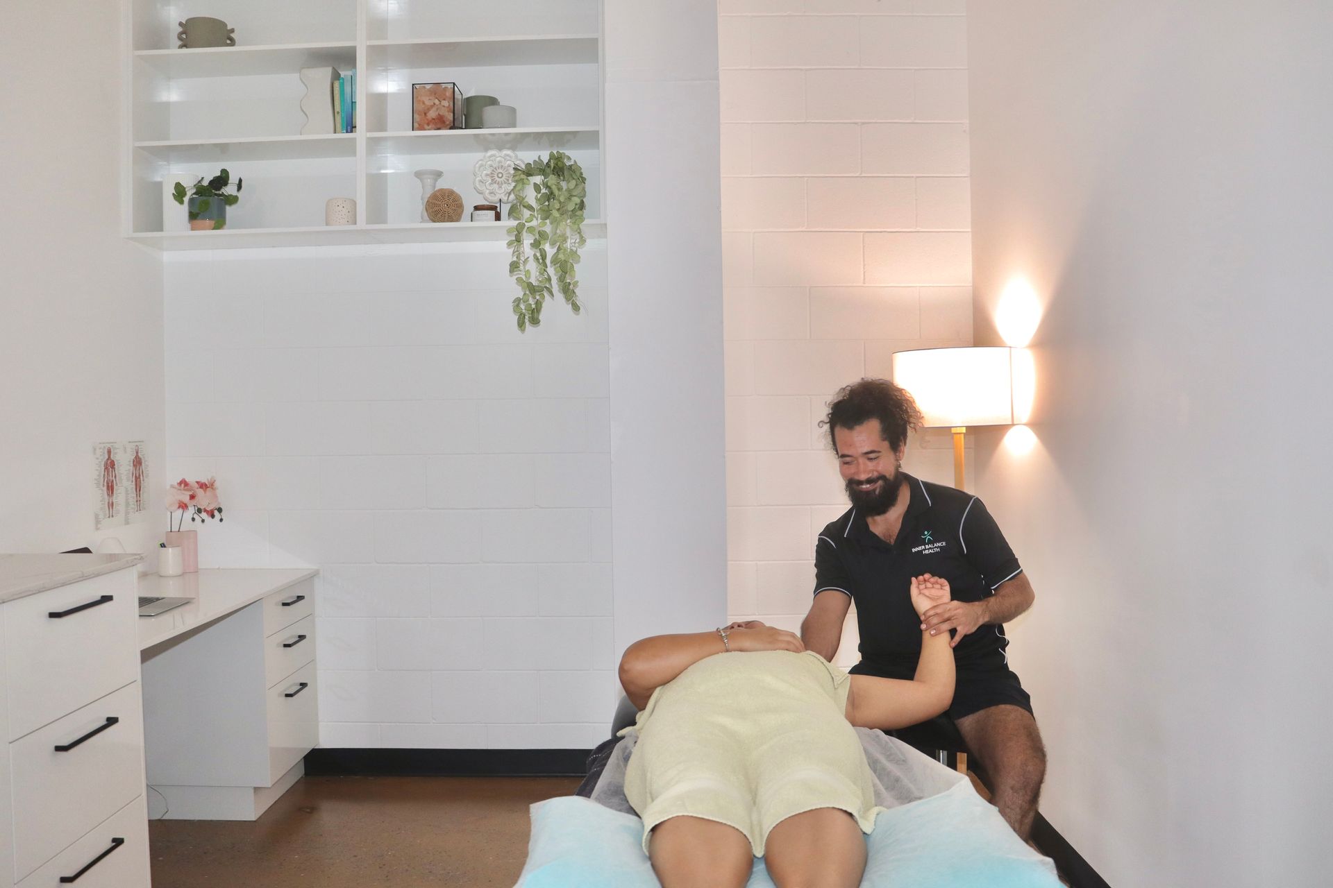 Physiotherapist A Beard Is Giving Another Man A Leg Massage — Inner Balance Health in Coconut Grove, NT