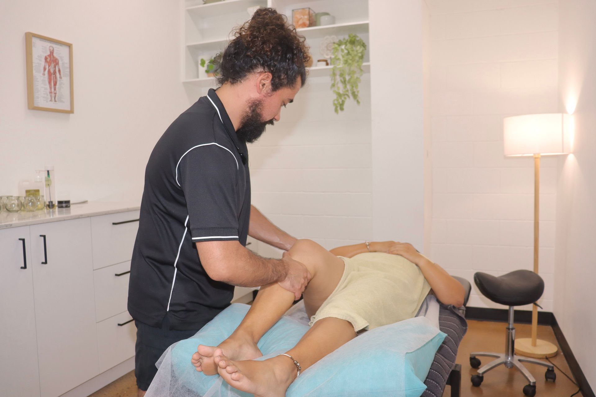 A Man In A Black Shirt Is Giving A Man A Nice Massage — Inner Balance Health in Coconut Grove, NT