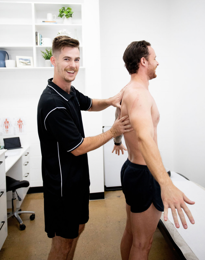 Physiotherapist Touching Man's Back — Inner Balance Health in Coconut Grove, NT