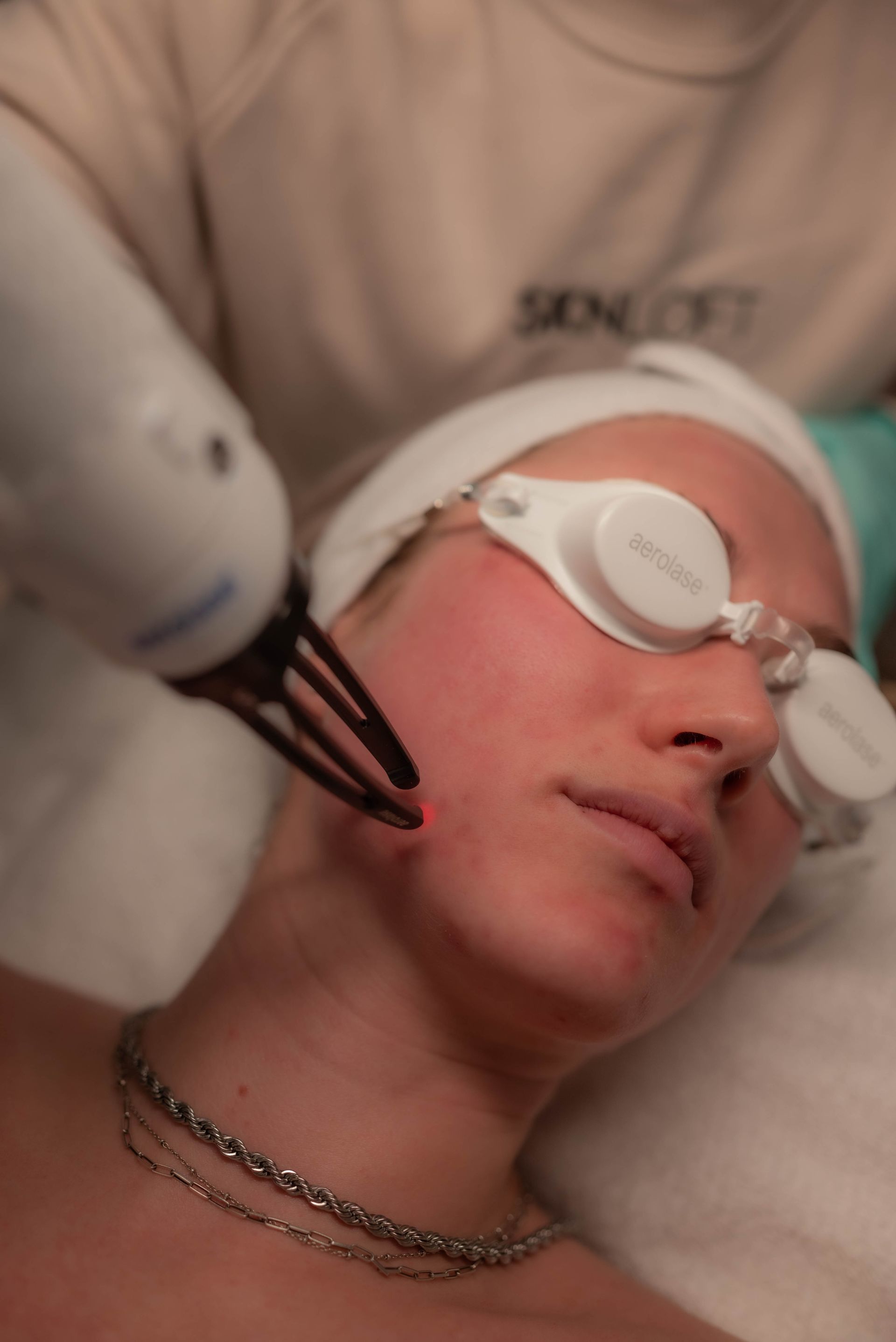 a woman is getting a laser treatment on her face .