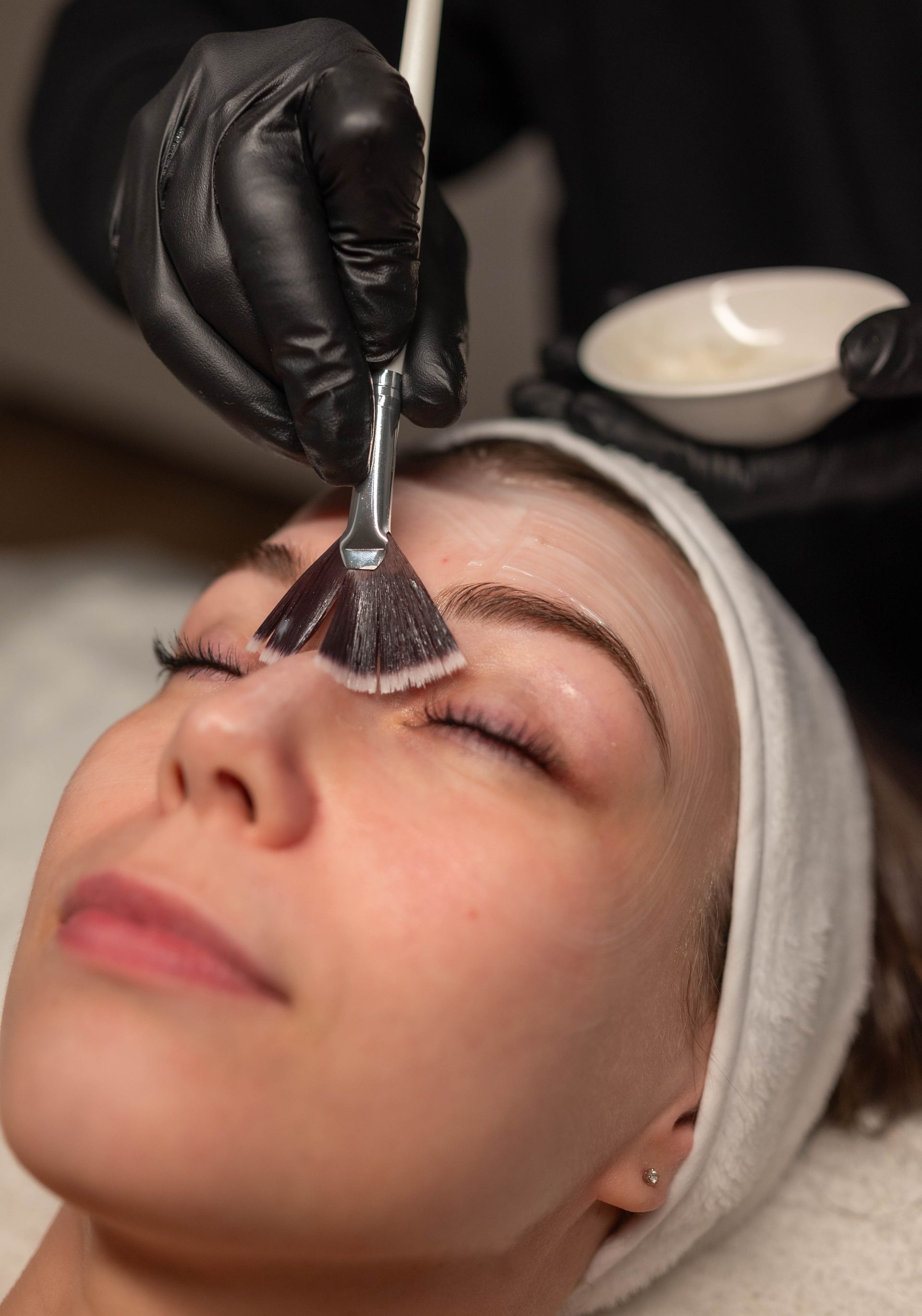 a woman is getting a facial treatment at a spa .