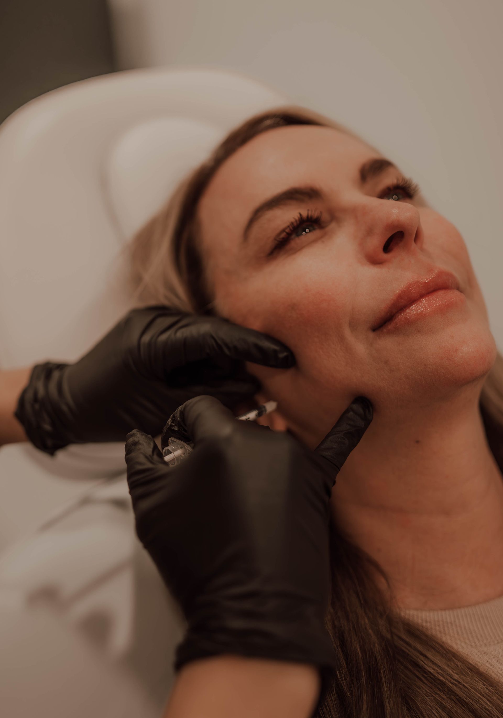 a woman is getting a facial treatment at a beauty salon .