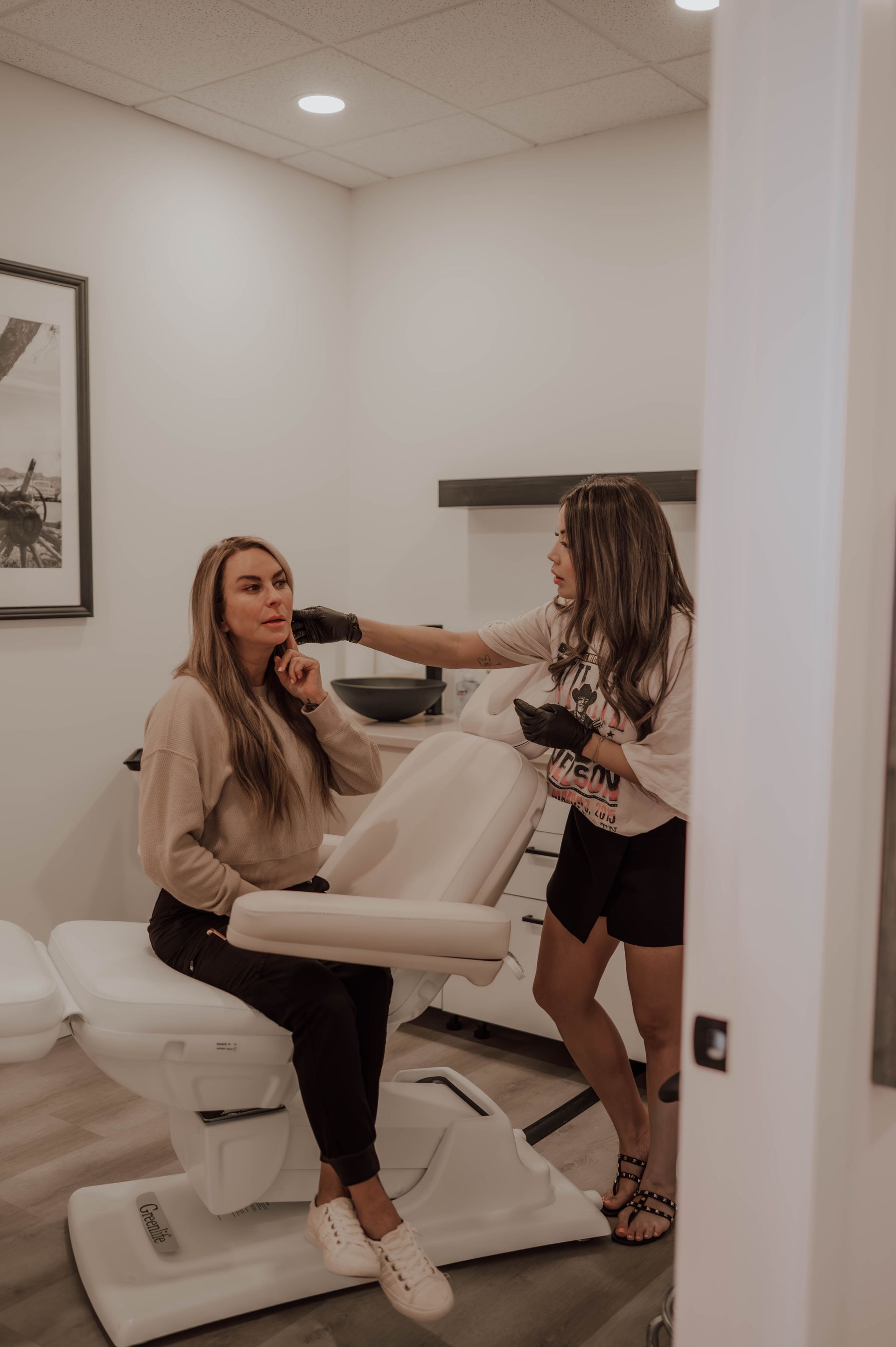 a woman is touching her eyebrows with her hands .