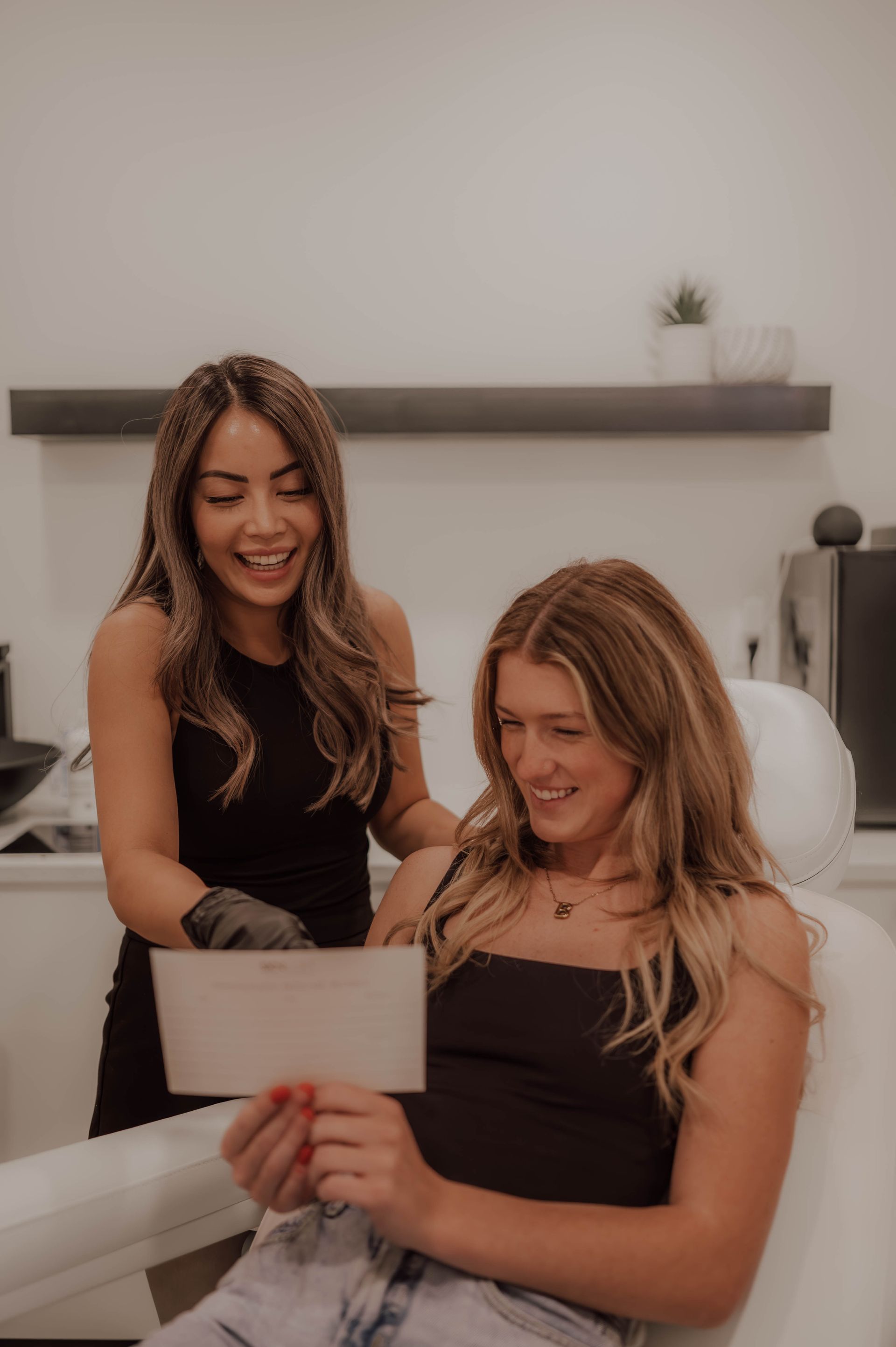 a woman is touching her eyebrows with her hands .