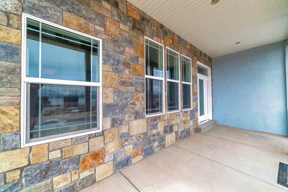 A Stone Wall with a Lot of Windows on It — Bulli Glass in Shellharbour, NSW