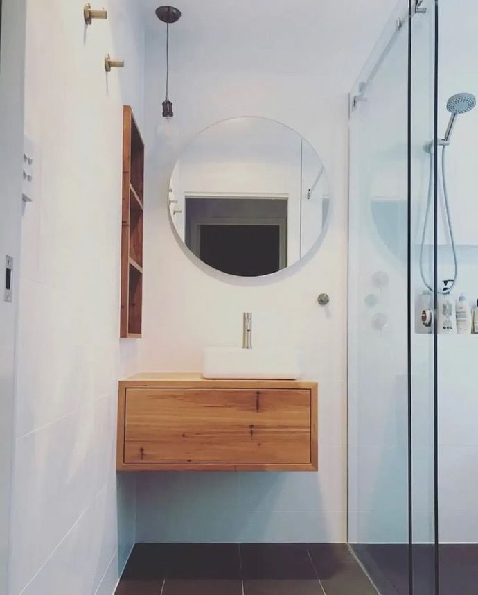 A Bathroom with a Sink and a Round Mirror — Bulli Glass in Bulli, NSW