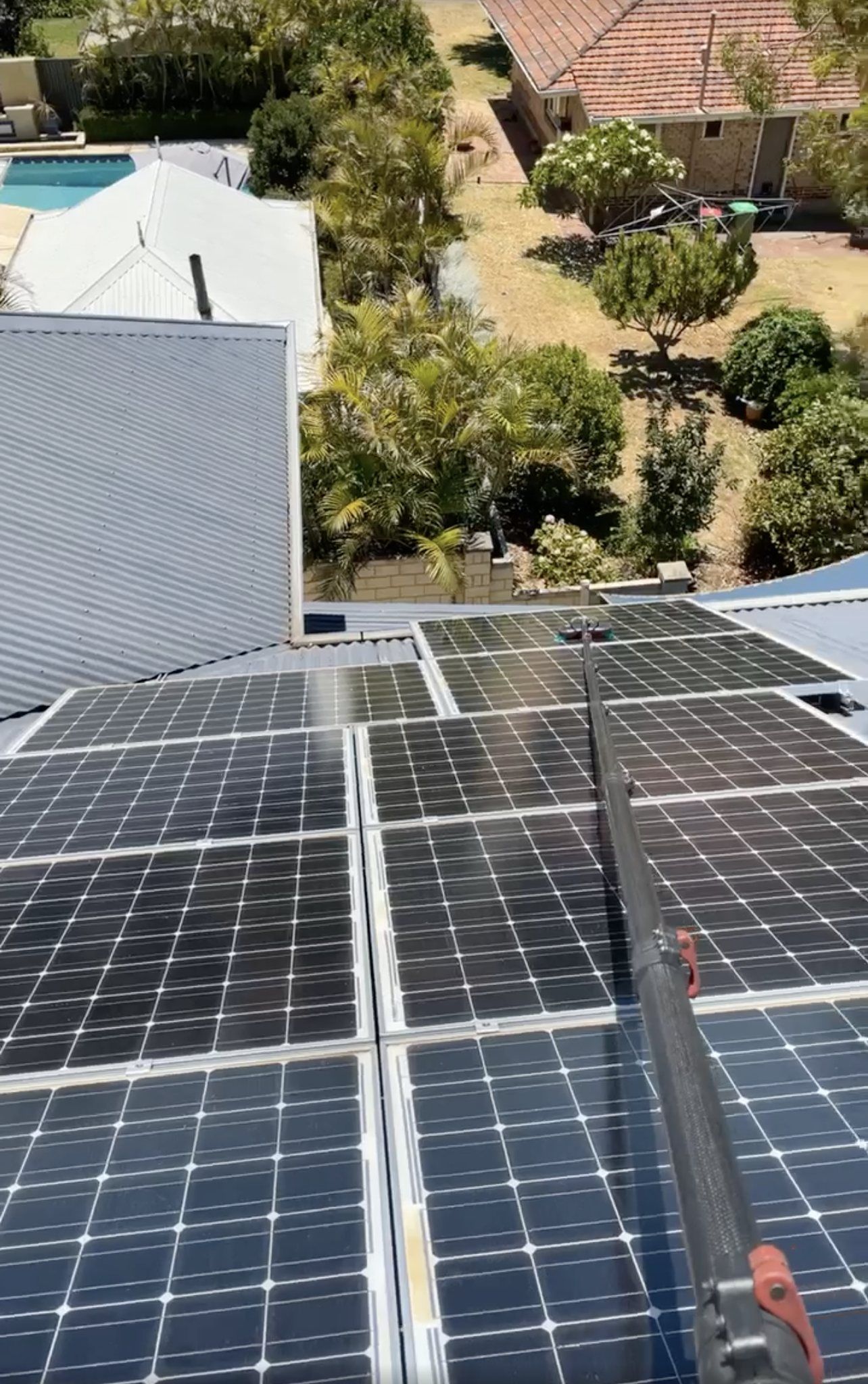 A row of solar panels on the roof of a house.