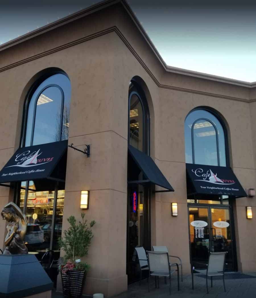 A building with arched windows and a sign that says ' g & g ' on it