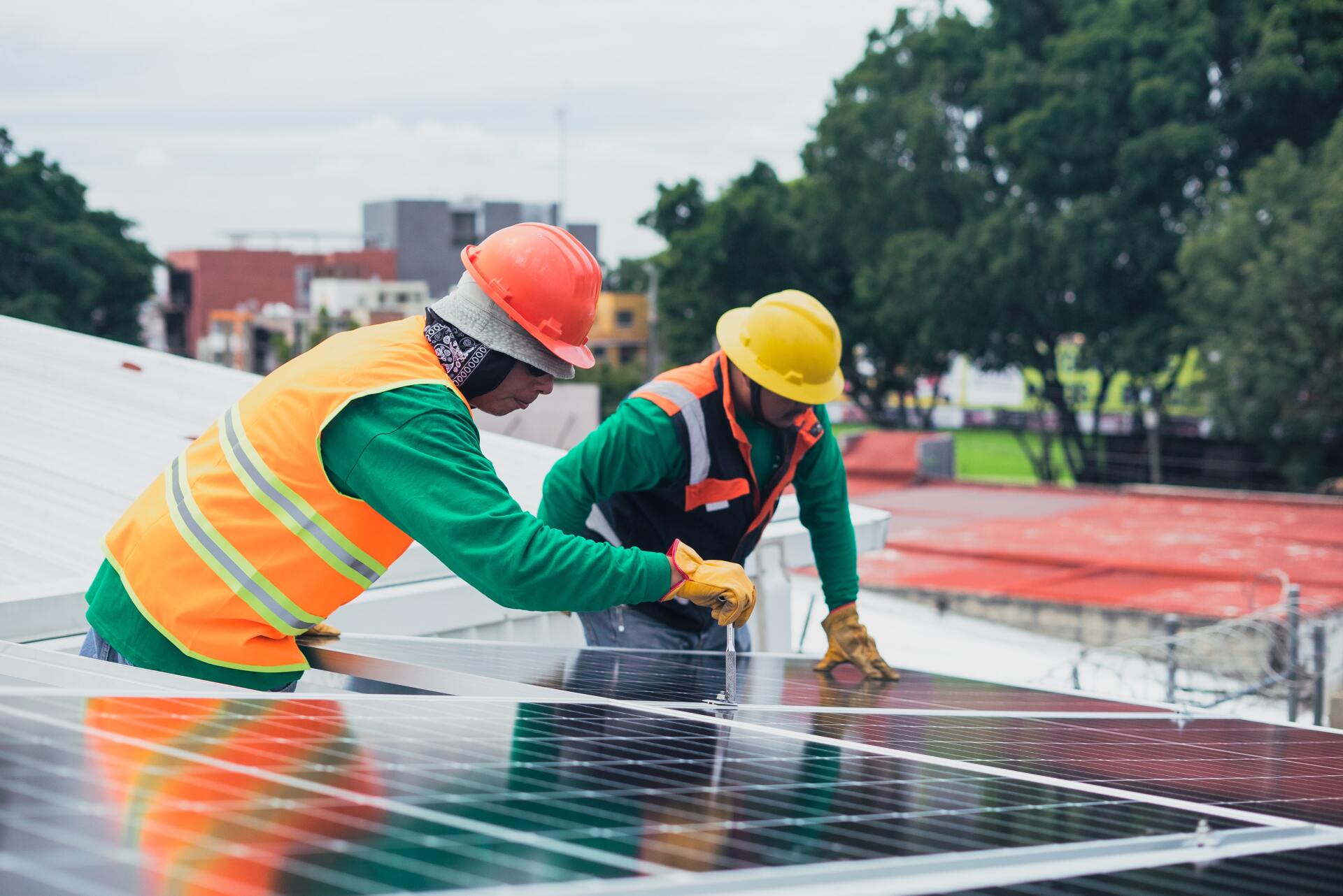 Digital Public Goods and Digital Public Infrastructure Men Installing Solar Panels for ESG Reporting
