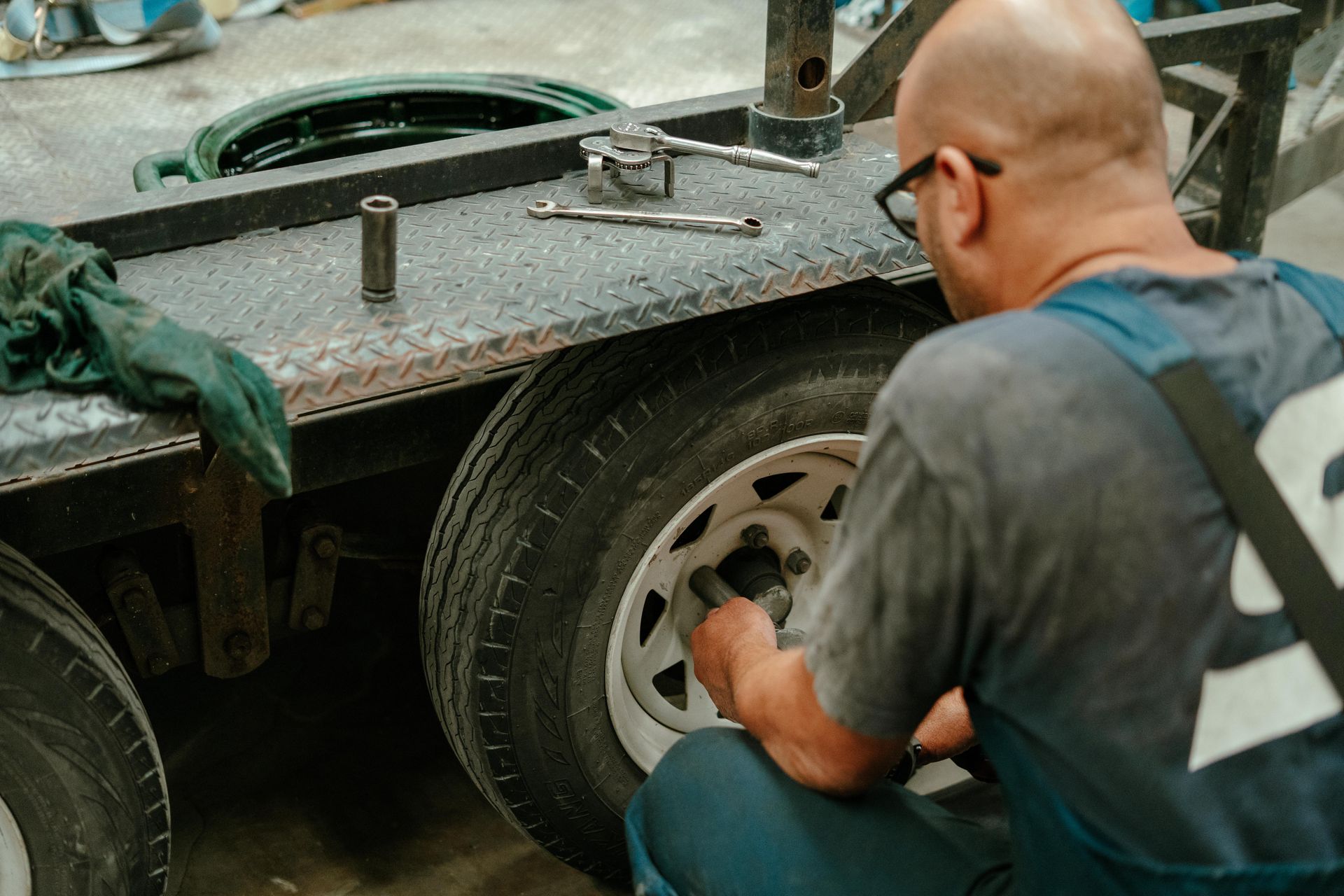 Mechanic pouring oil from a yellow container into a car engine using a red funnel. — Navan Mobile Mechanic in Shellharbour, NSW