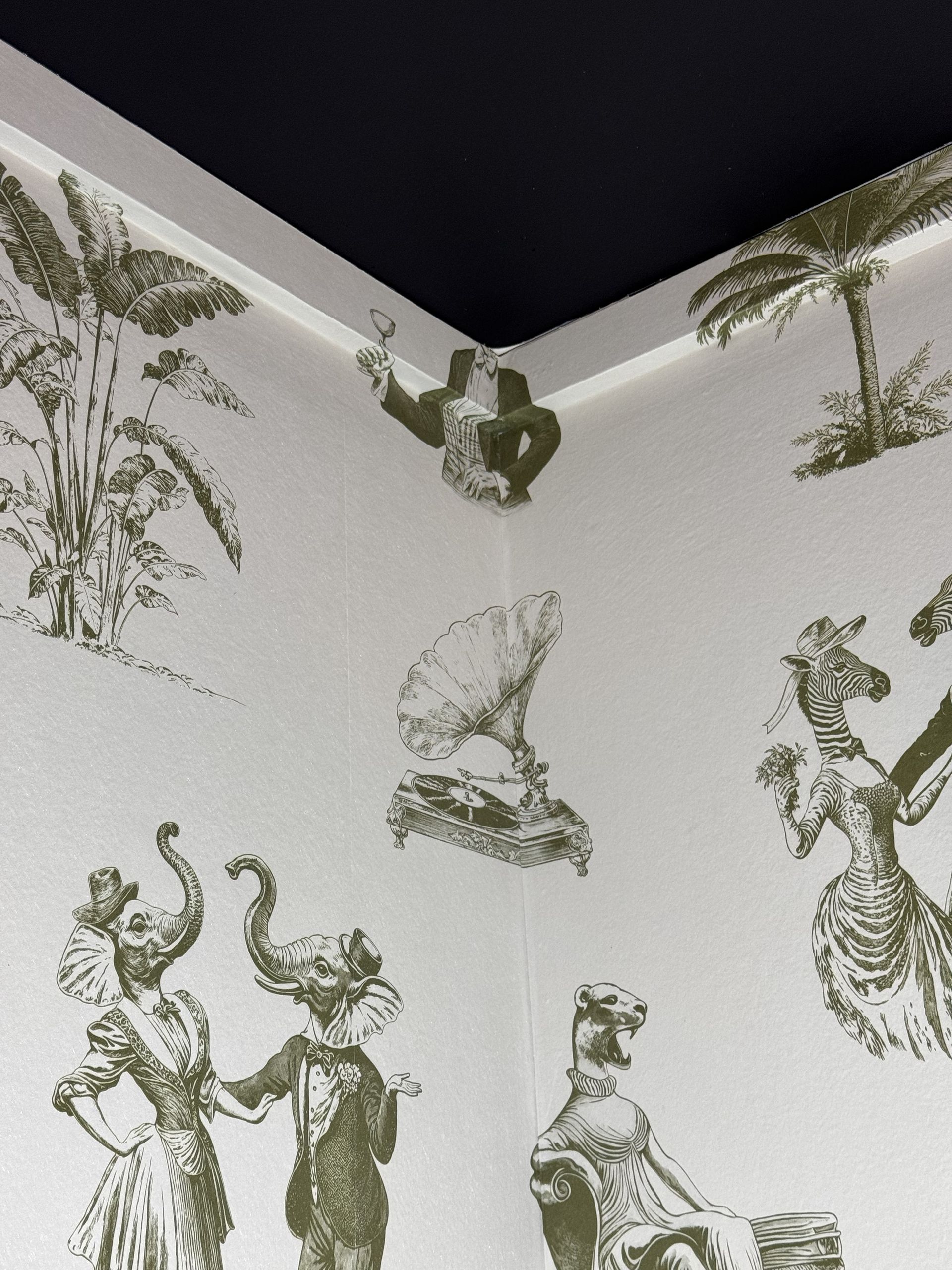 Wallpaper featuring olive-green illustrations of Victorian-style dressed animals and gramophones on a white background.