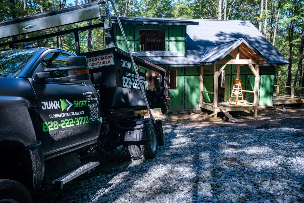 Junk Shift truck and dumpster at a wooded mountain home in Western North Carolina
