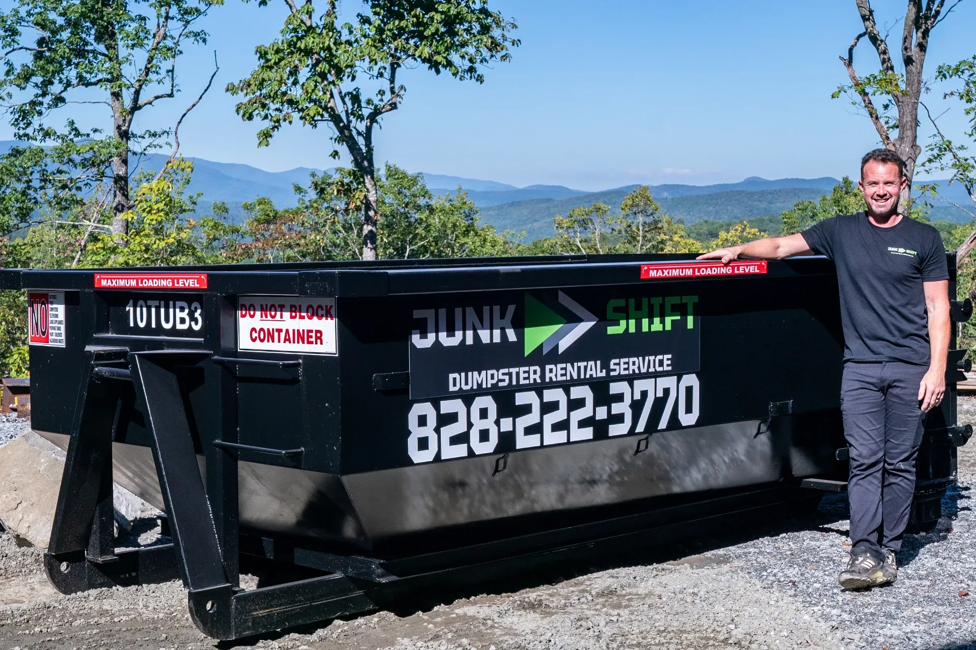 Junk Shift dumpster rental owner beside a roll-off dumpster in Western North Carolina