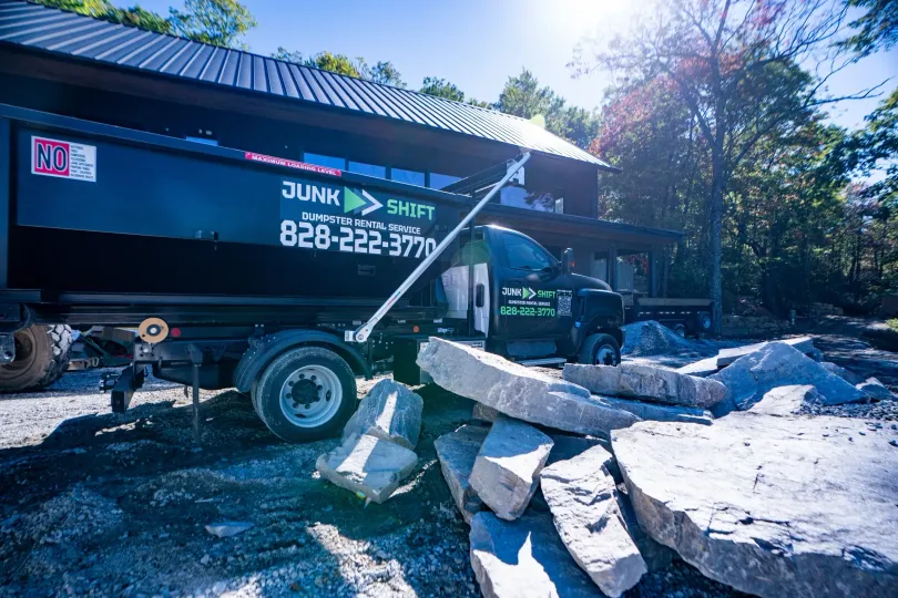 Junk Shift roll-off dumpster and truck at a Western North Carolina job site