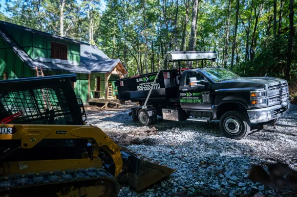 Junk Shift dumpster rental truck at a residential cleanup project